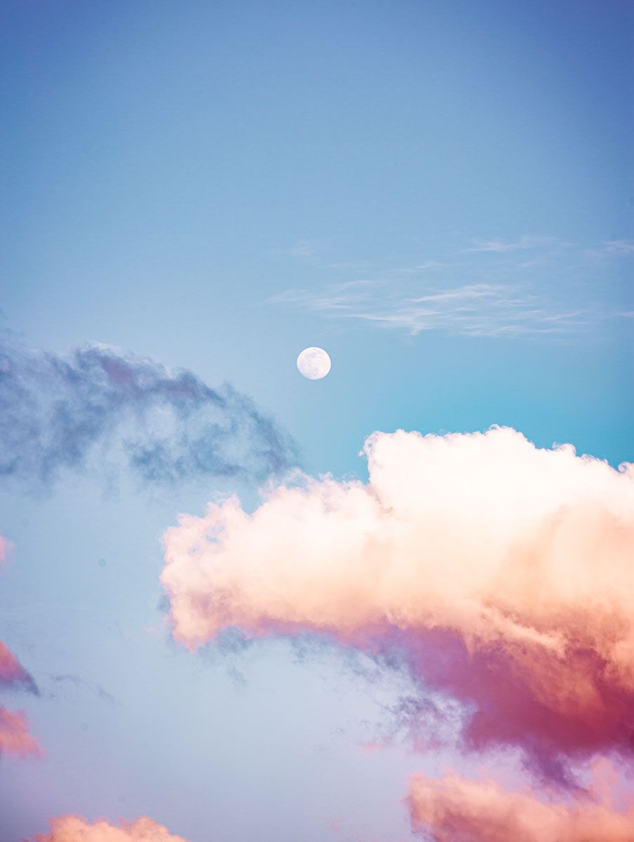 A photo of the moon in the sky with pink clouds - Pride
