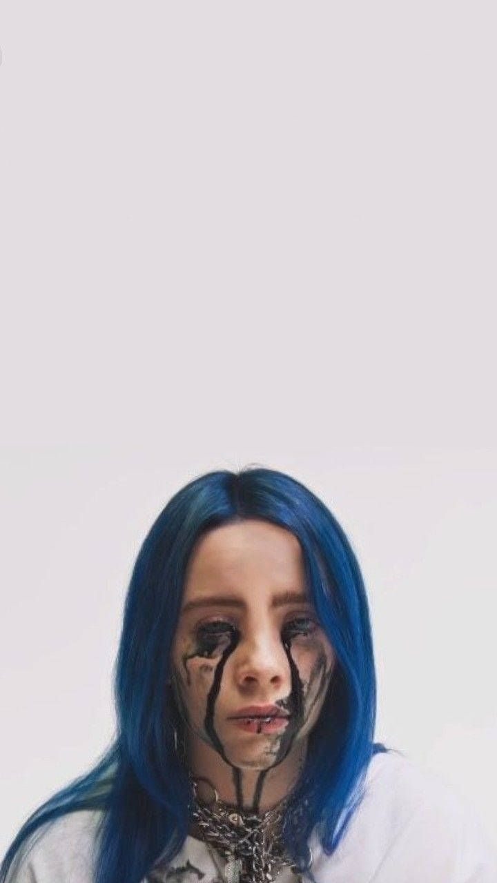 A woman with blue hair and makeup - Billie Eilish