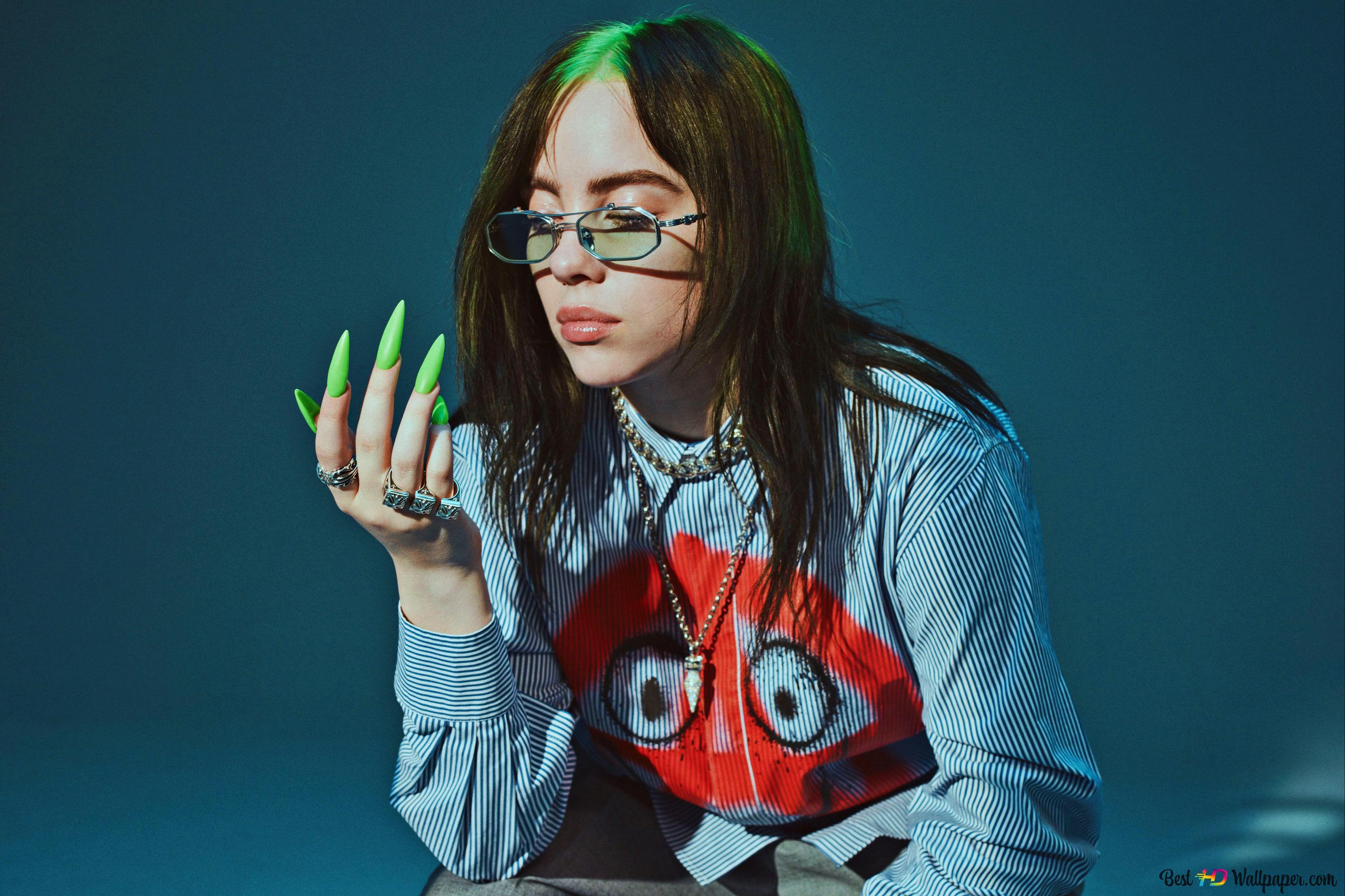 Cool singer Billie Eilish sitting in a stool with blue background 4K wallpaper download
