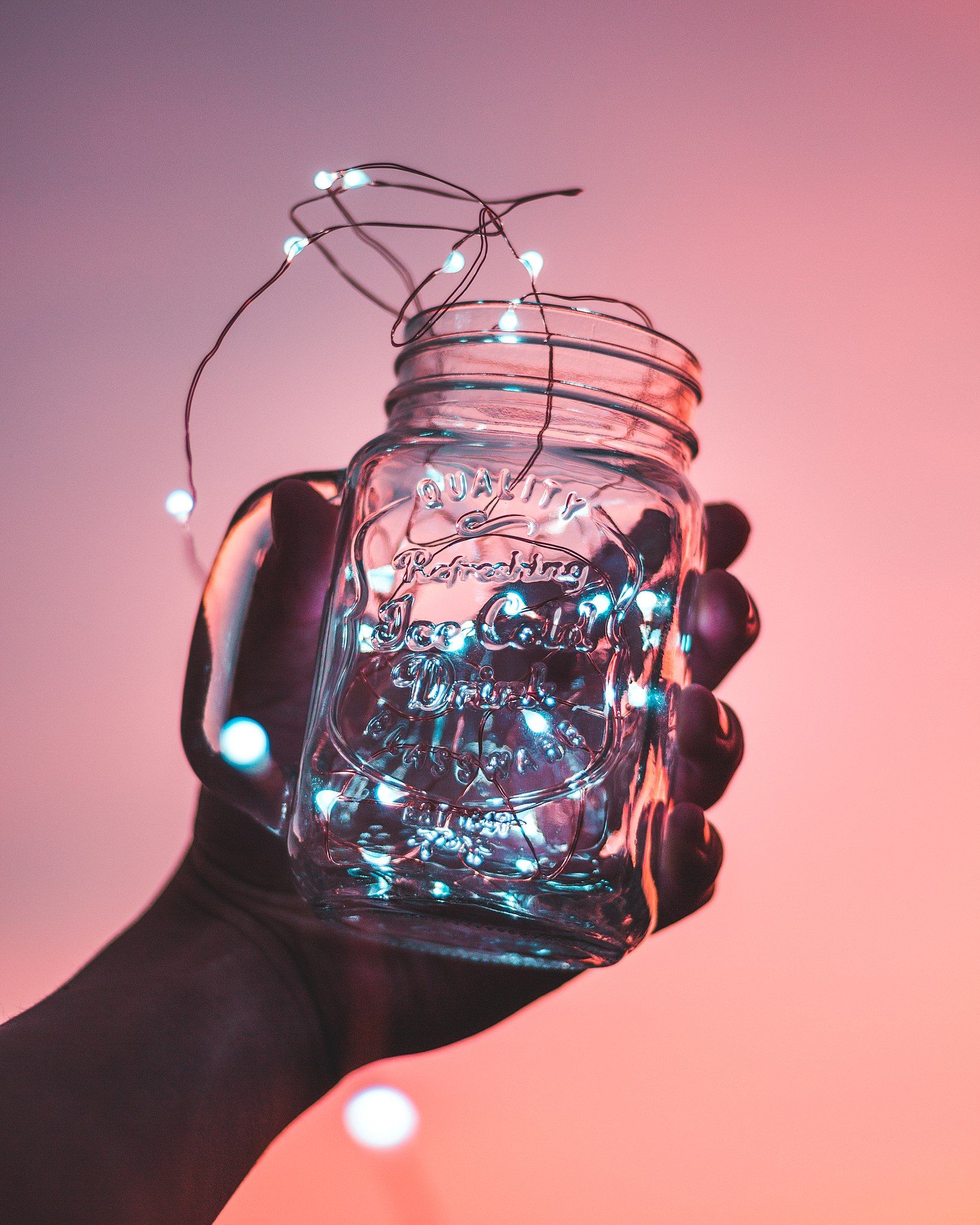 A person holding a jar with lights inside. - Mexico