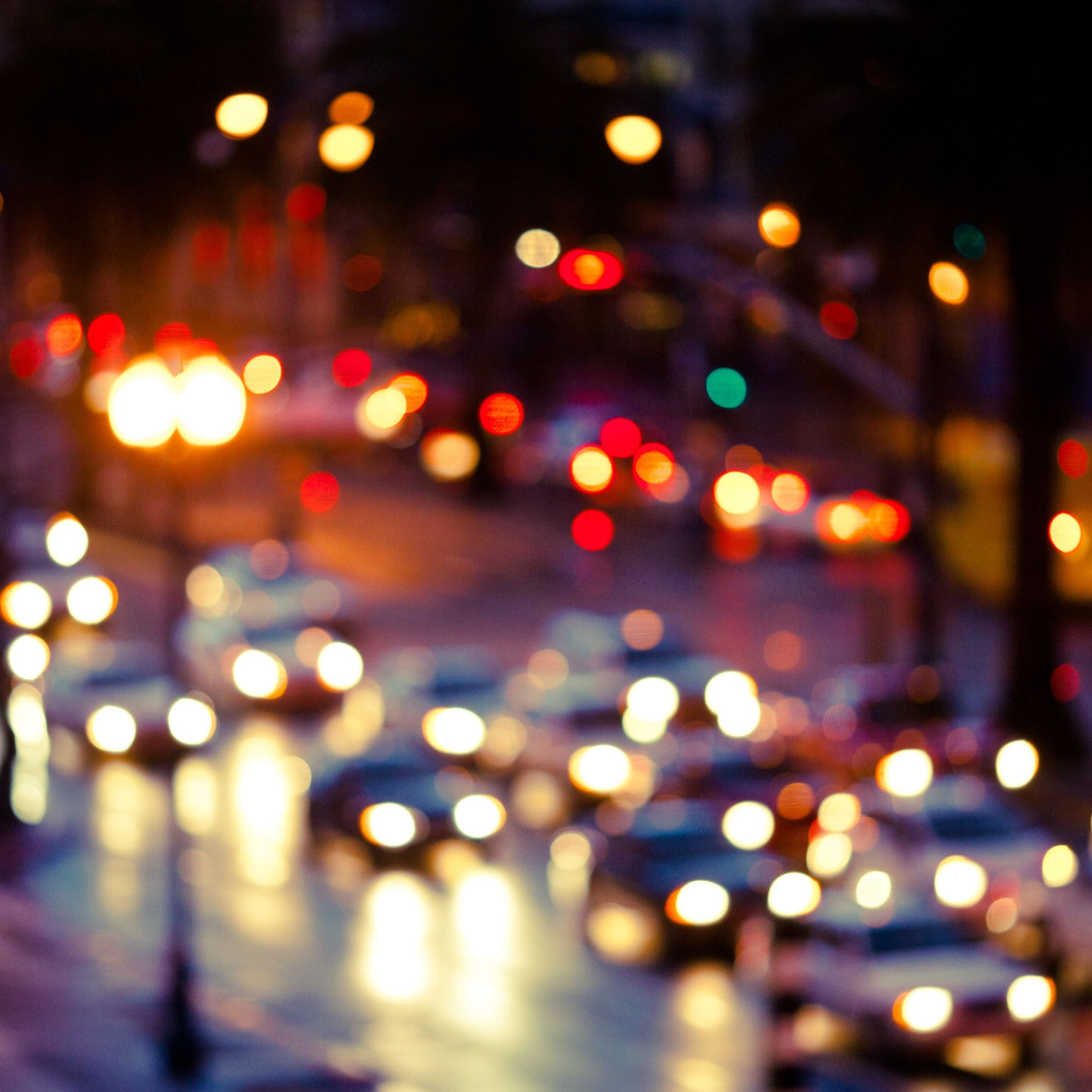 A blurry photo of a busy street at night with cars and street lights - Blurry