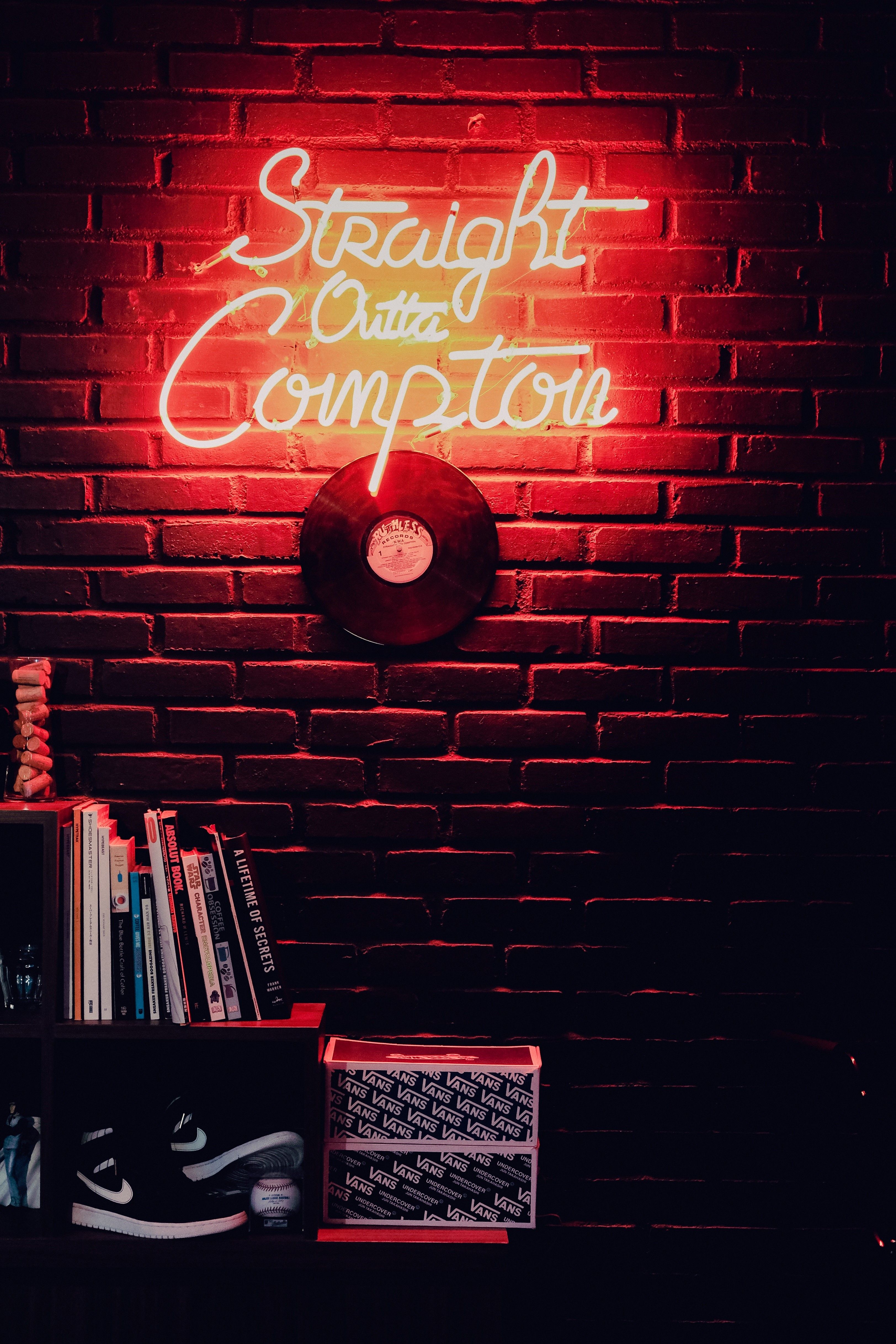 A neon sign that says strength over competition - Light red