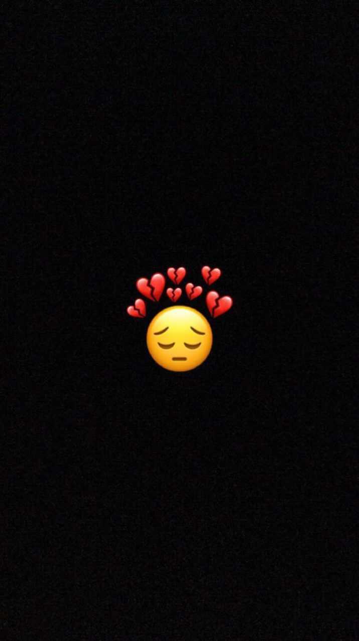 A dark room with an emoji face and hearts - Black heart