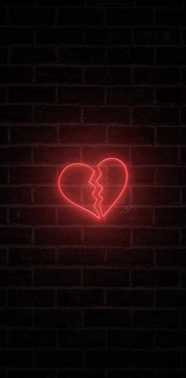 A broken heart neon sign on a brick wall - Black heart