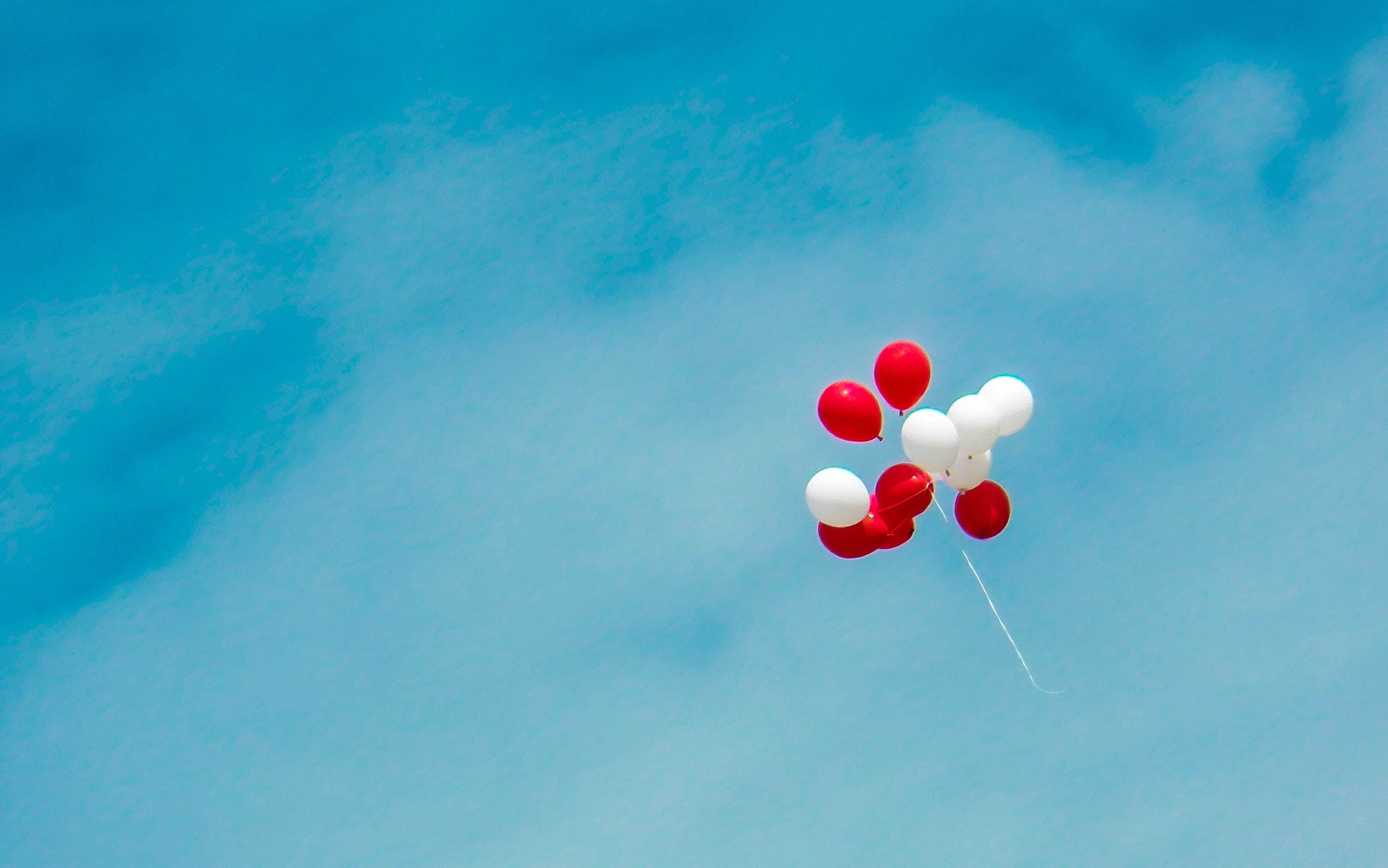 A red and white balloon flying in the sky - Sky, balloons
