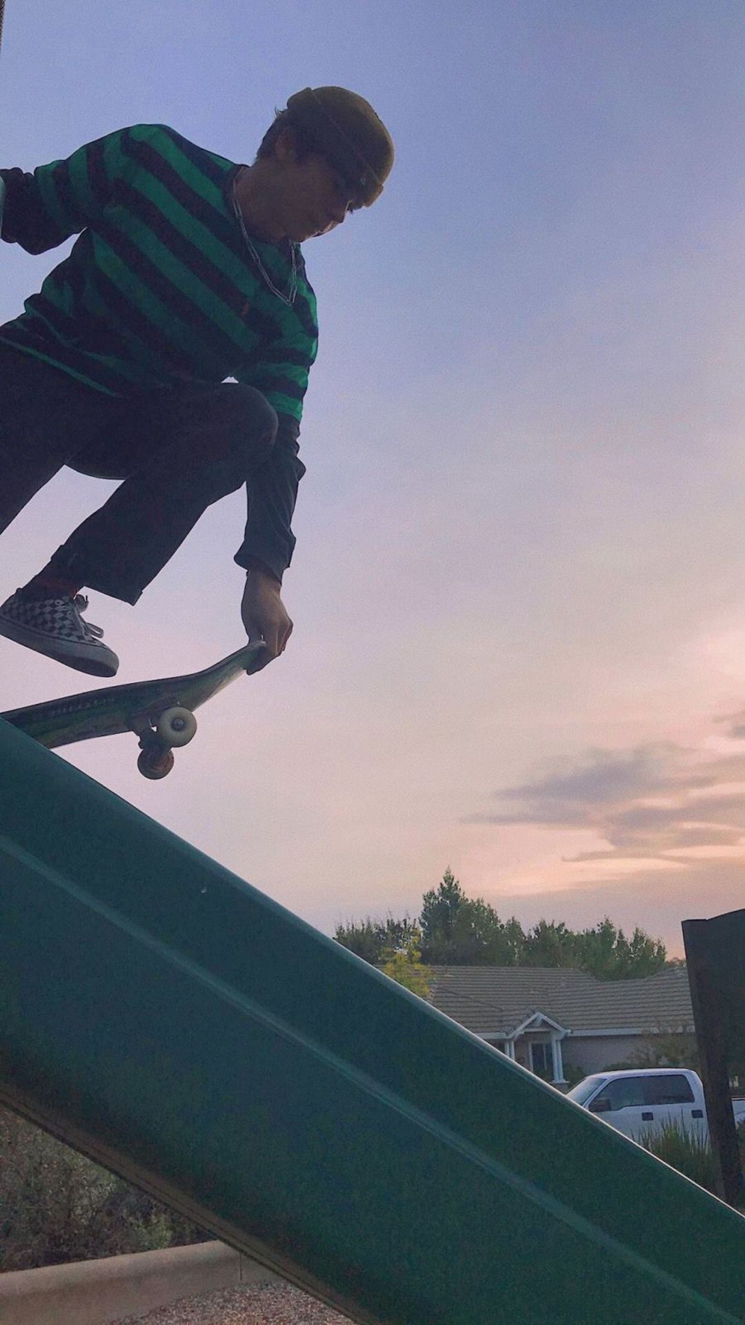 A person riding a skateboard down a green ramp - Skate, skater