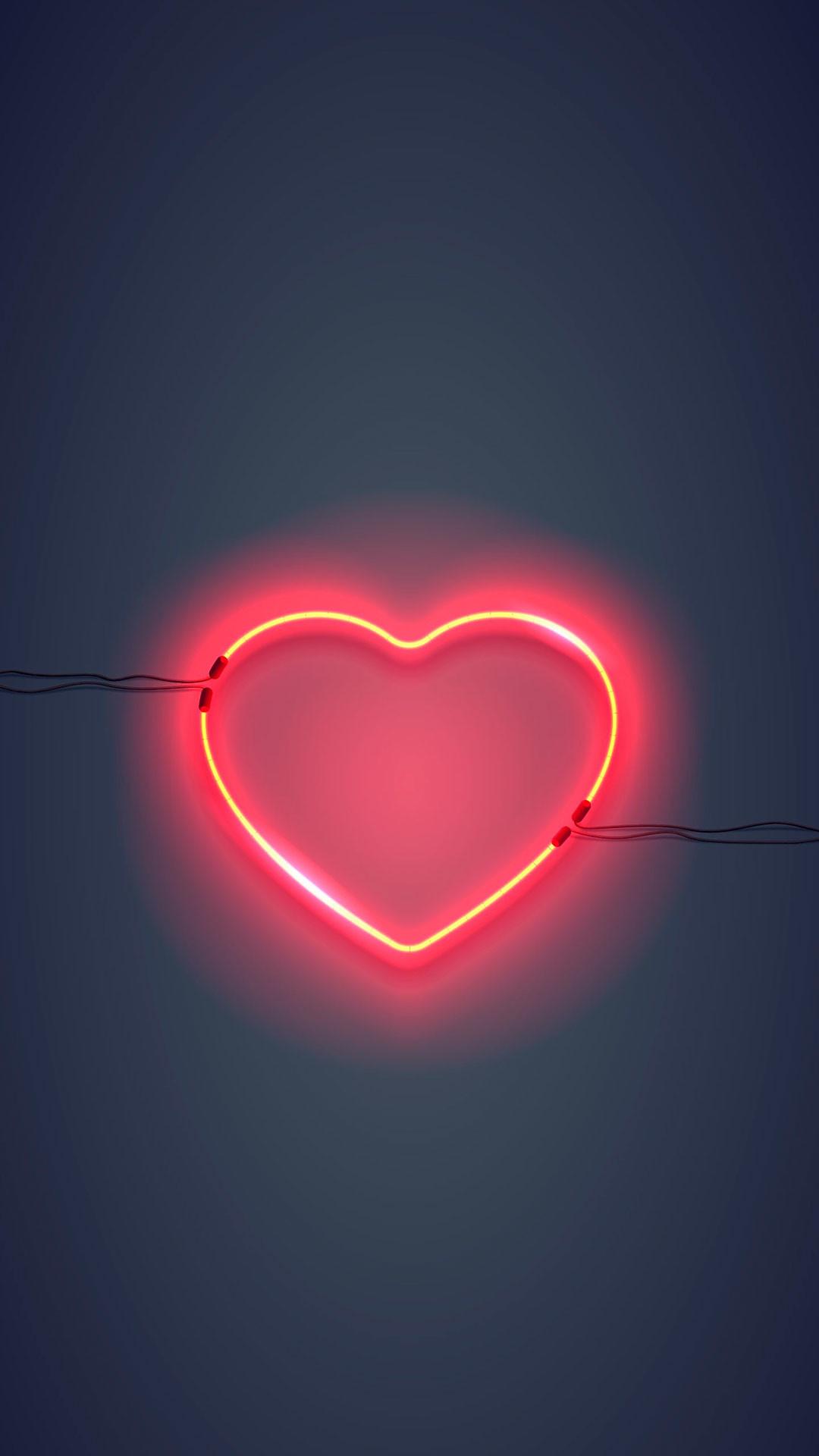 A neon heart on a dark background - Light red