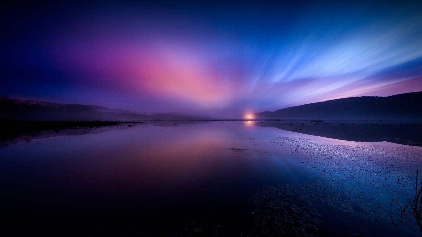A lake at night with a purple and blue sky - 1366x768