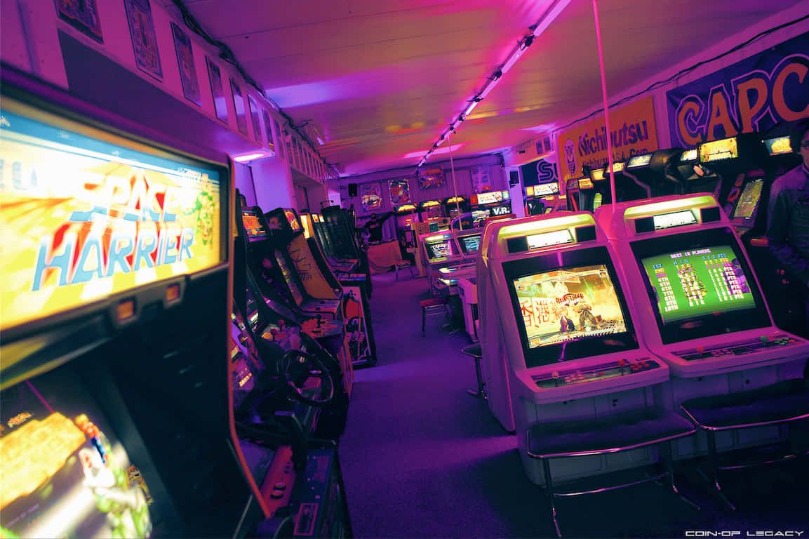 A room full of video games with neon lights. - Arcade