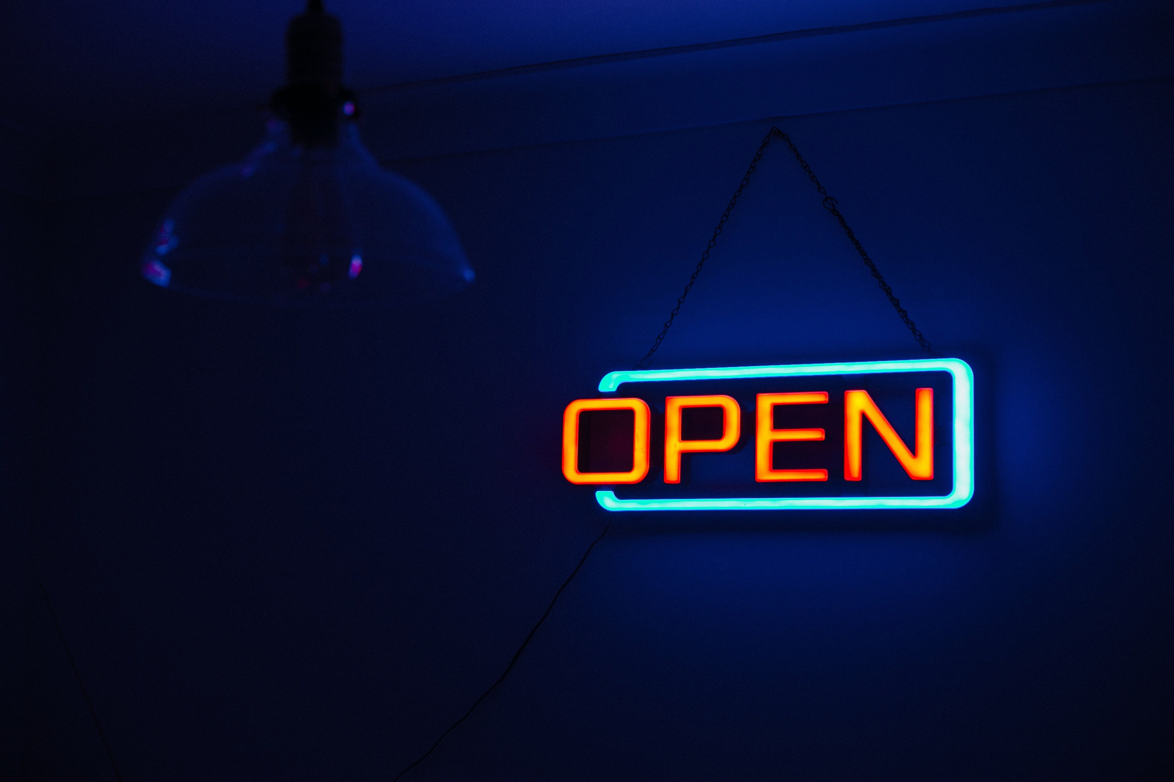 A neon sign that says open - Neon