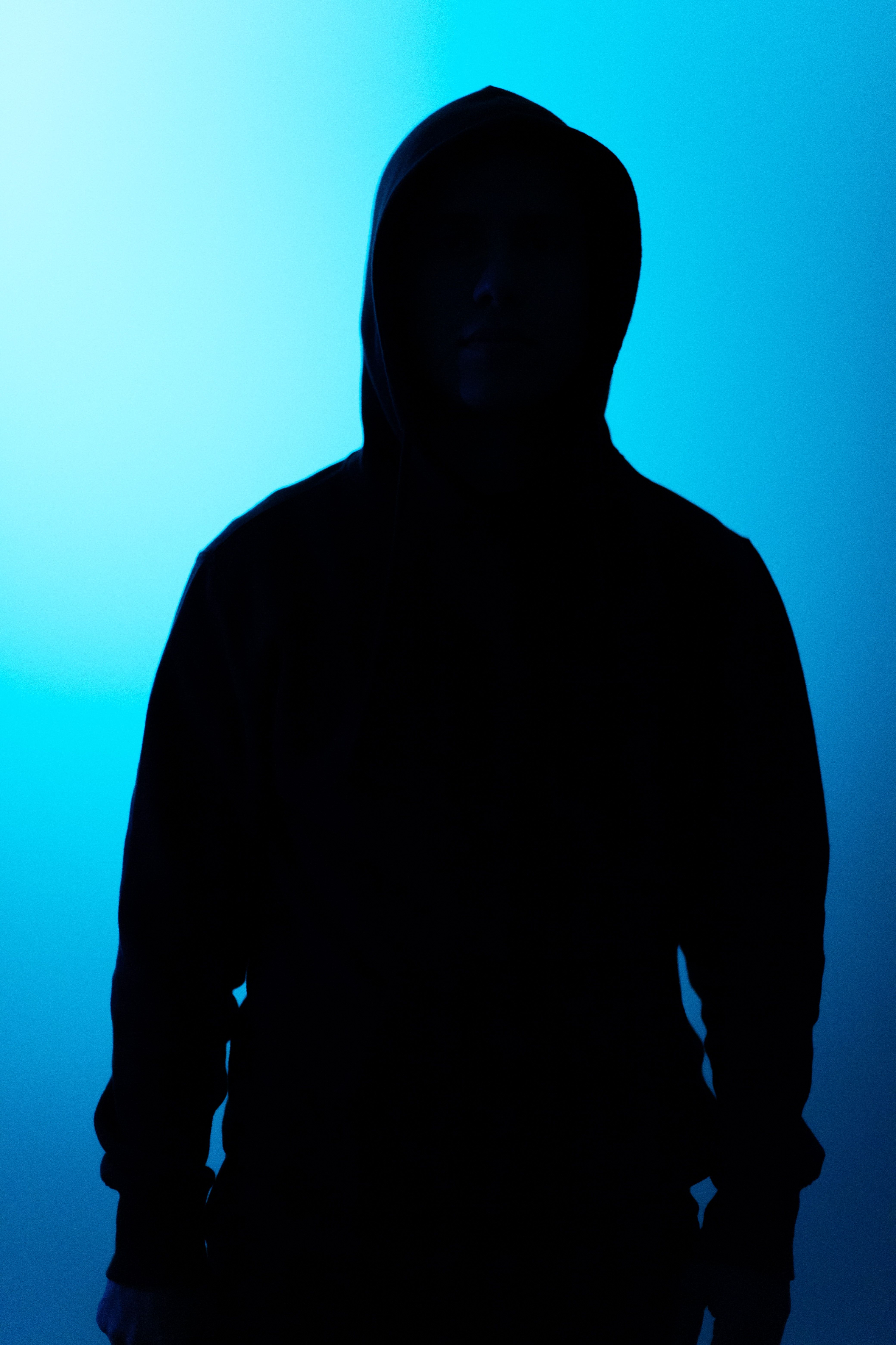 A man standing in front of blue light - Sad, creepy