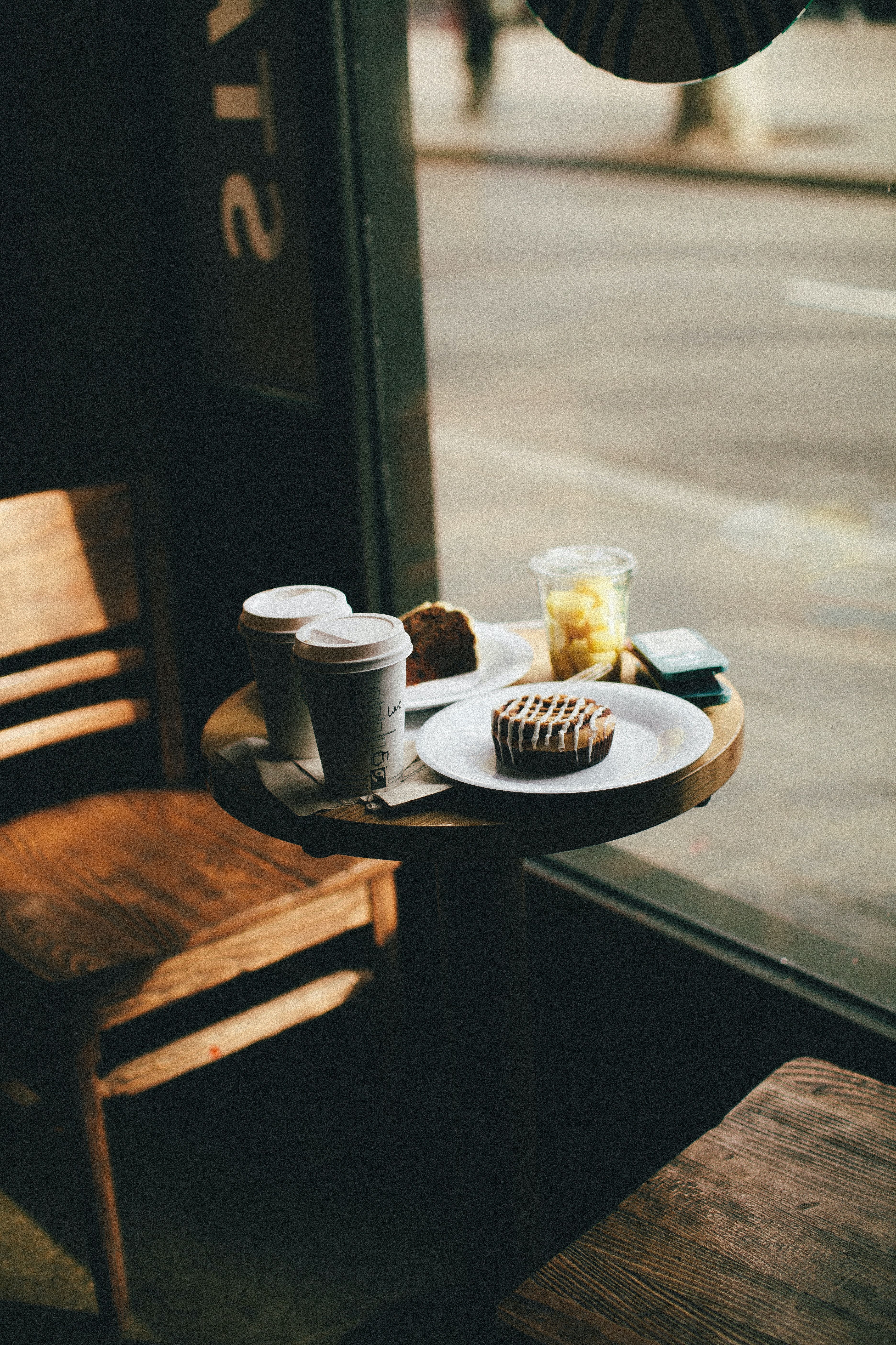 A table with two cups of coffee and some food - Coffee