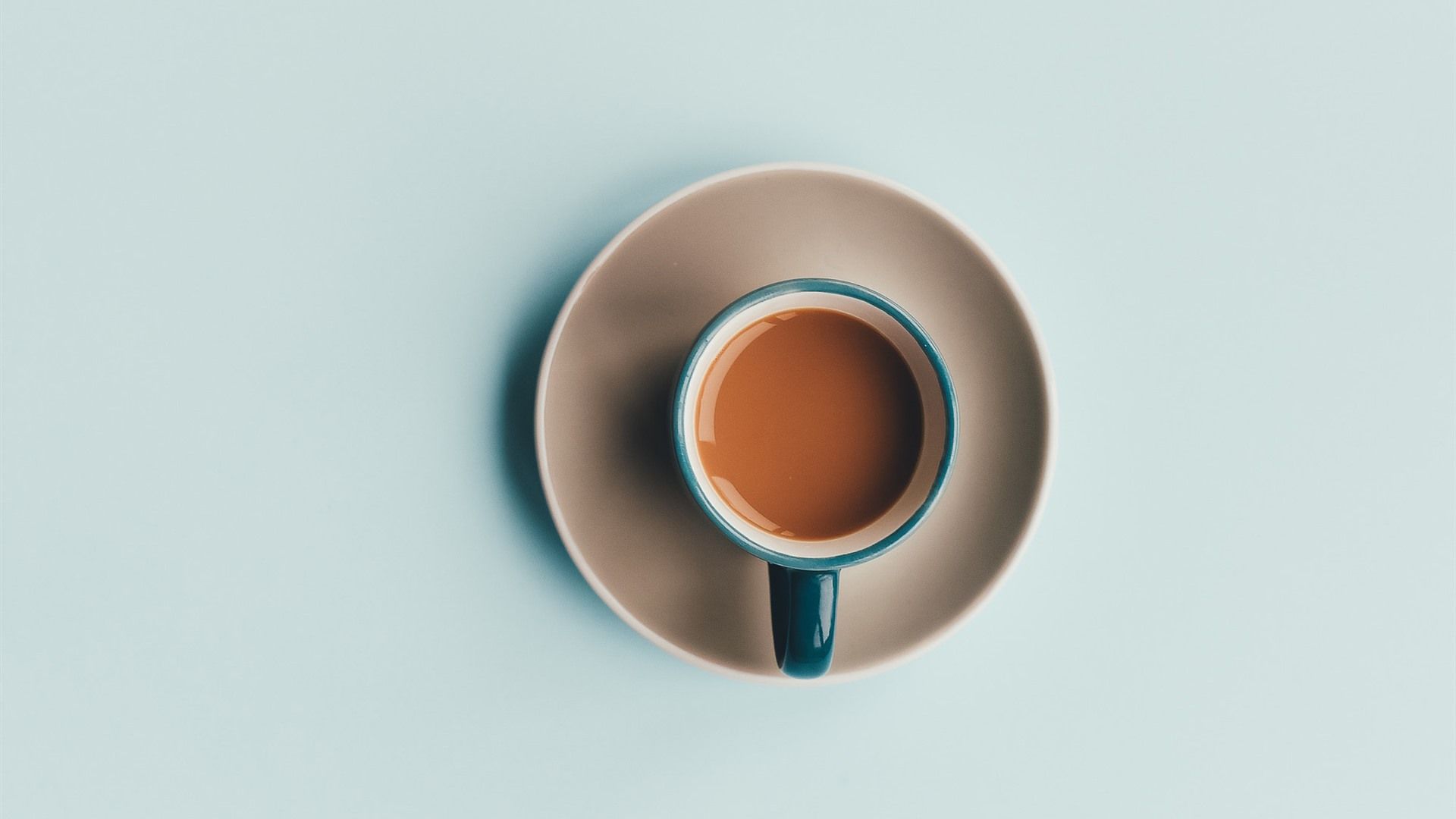 A cup of coffee on a saucer on a blue background - Coffee