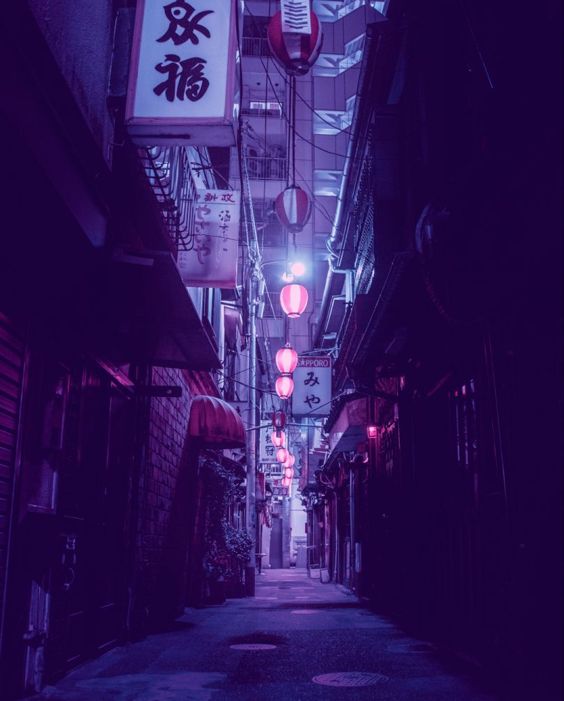 A dark alley with many lanterns hanging from the ceiling - Tokyo