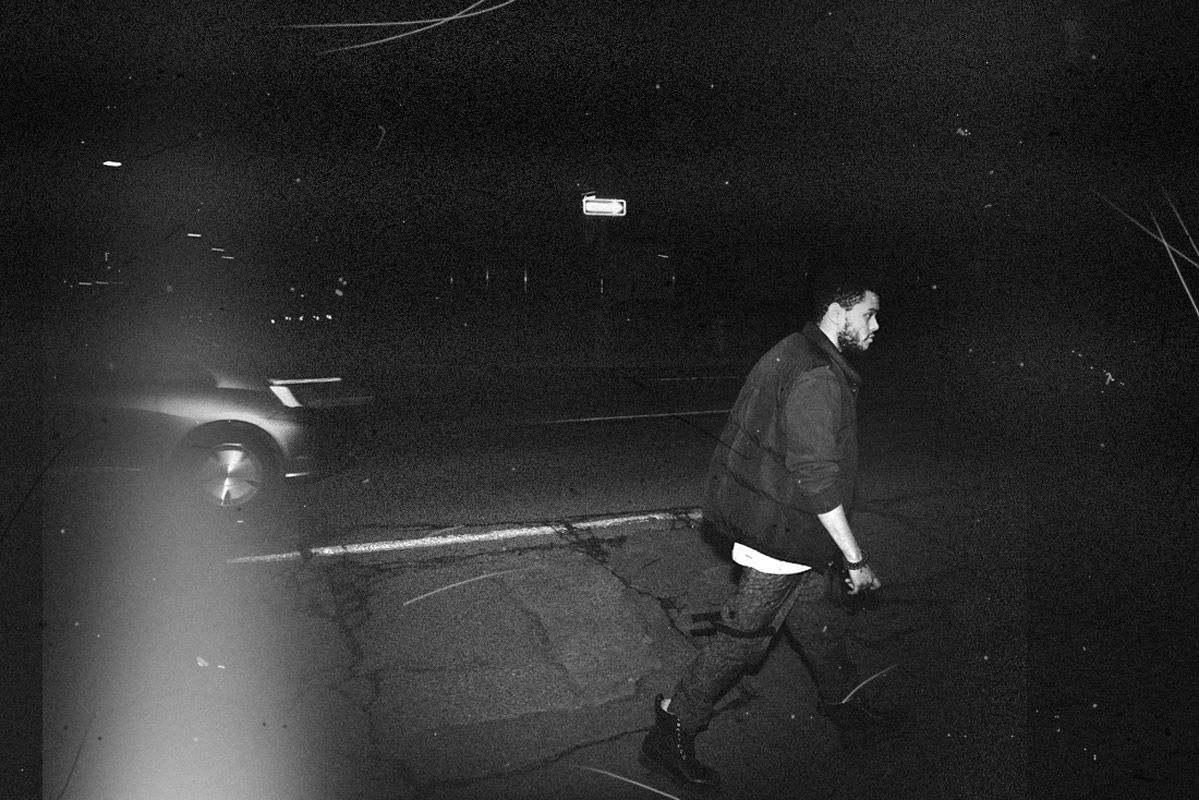A man walking down the street with his skateboard - The Weeknd