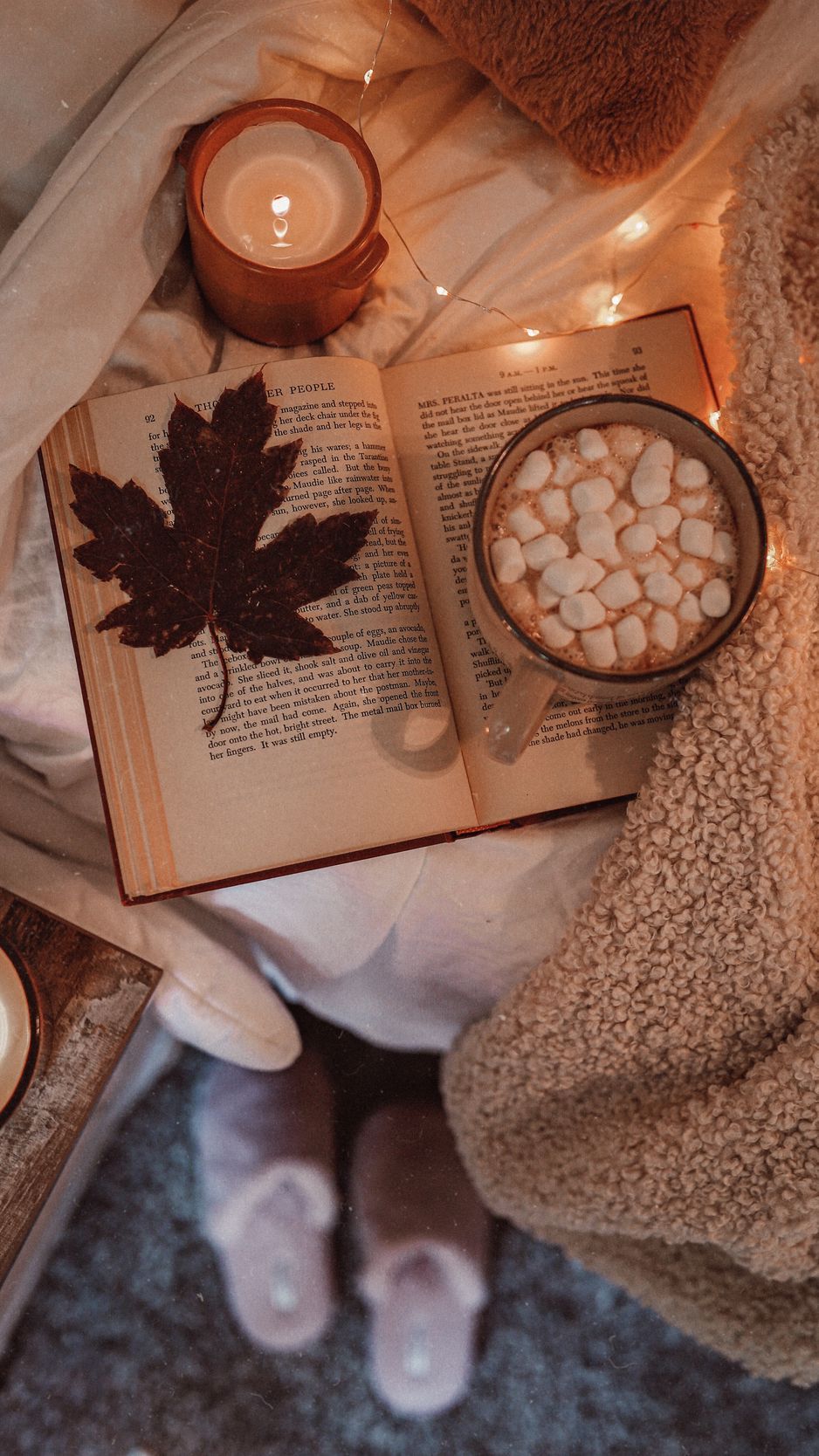 A book and some marshmallows on top of the bed - Cozy