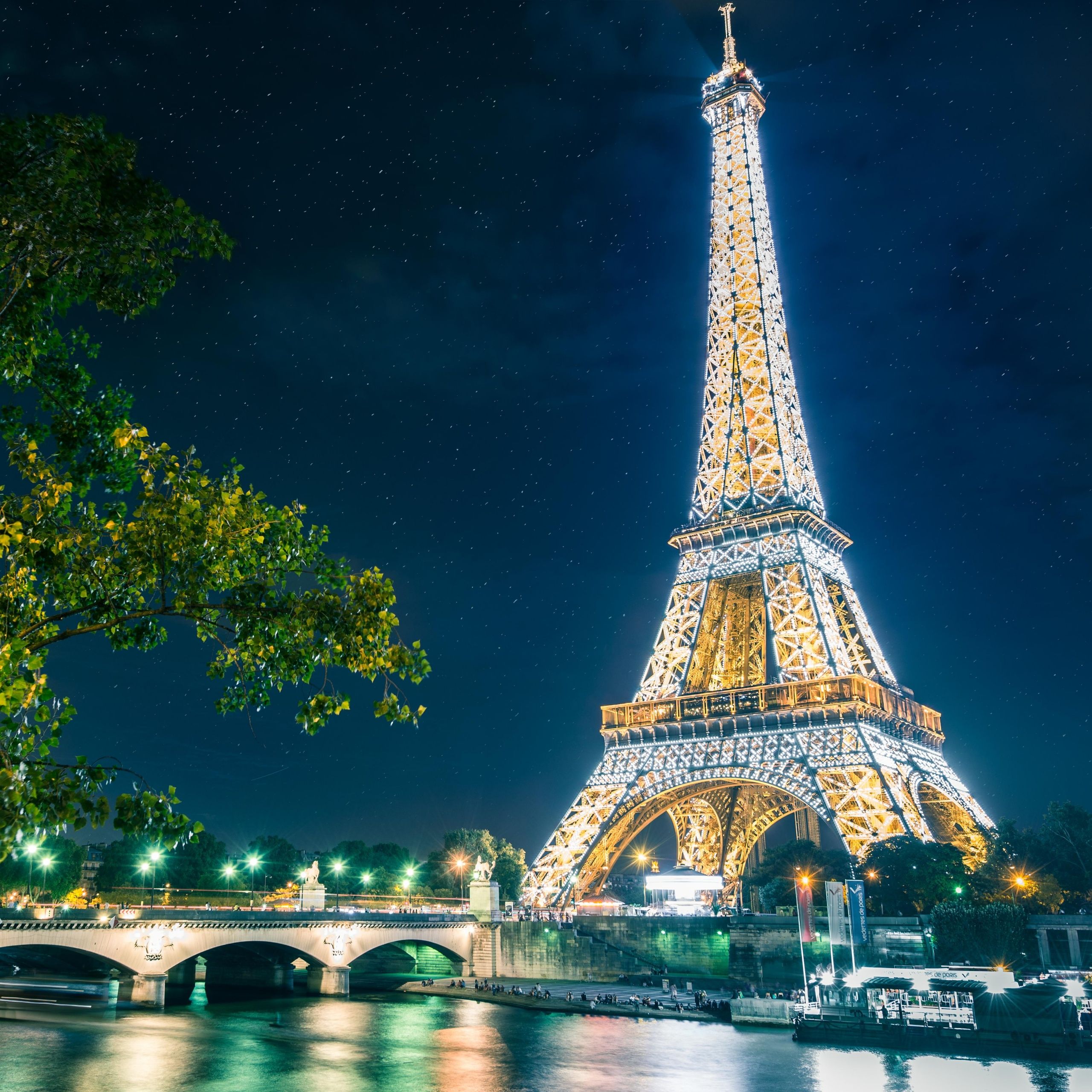 The eiffel tower is lit up at night - Eiffel Tower, Paris