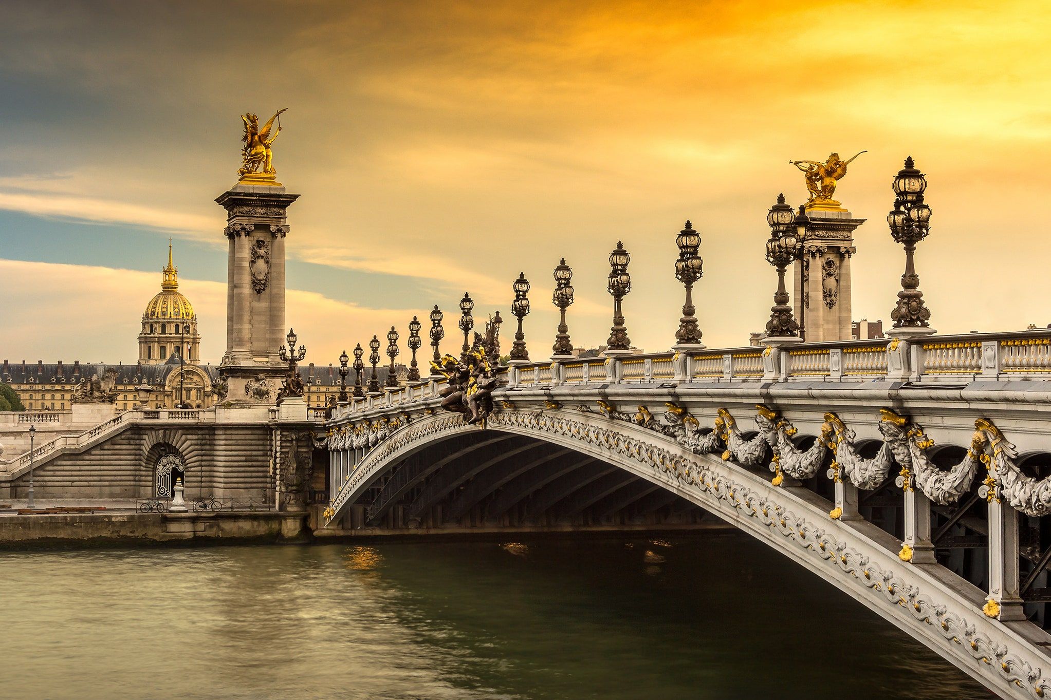 A bridge in Paris with a sunset in the background - Paris