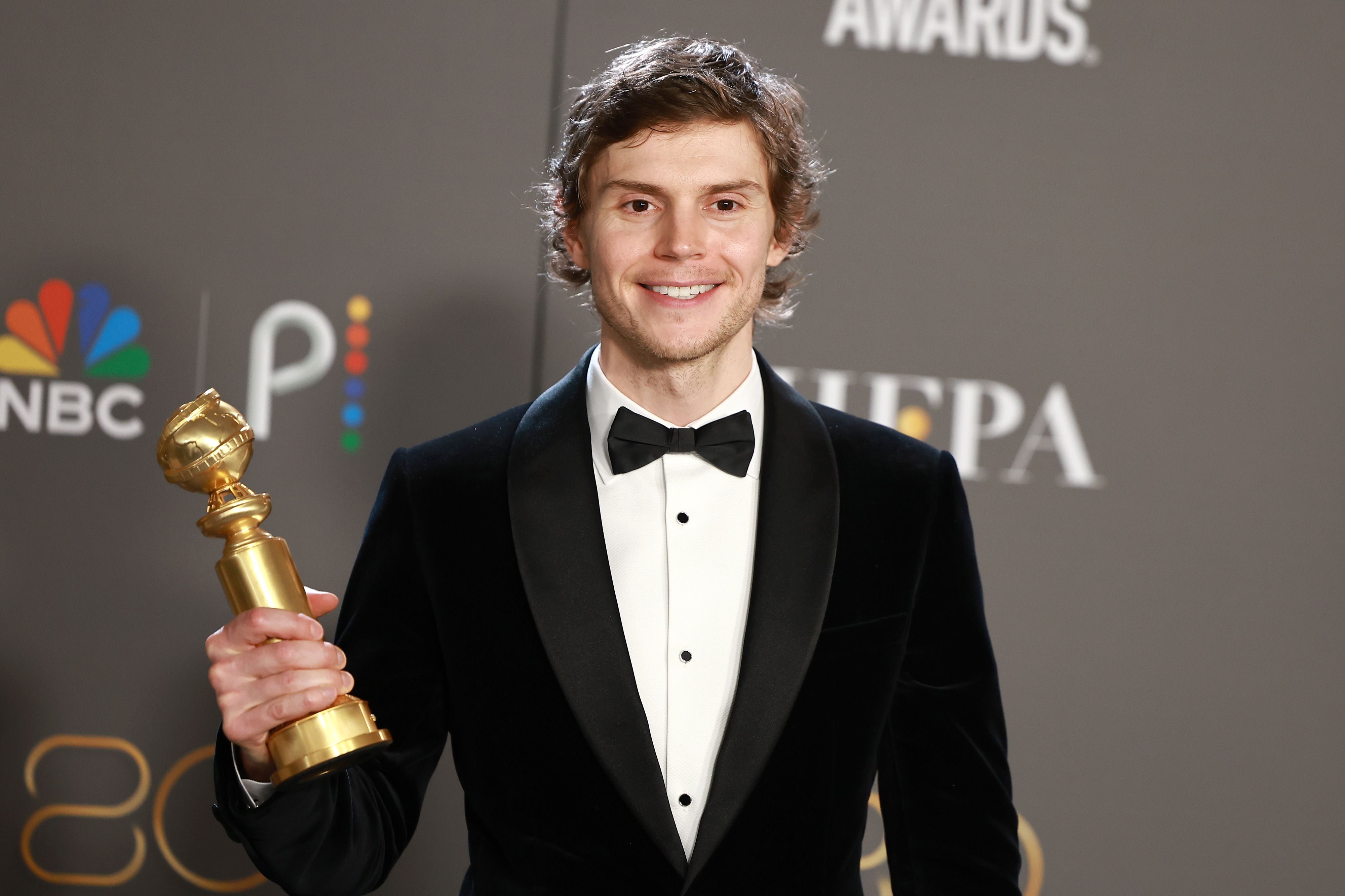 Evan Peters poses with his Golden Globe award for 'American Horror Story: Hotel' in 2016. - Evan Peters