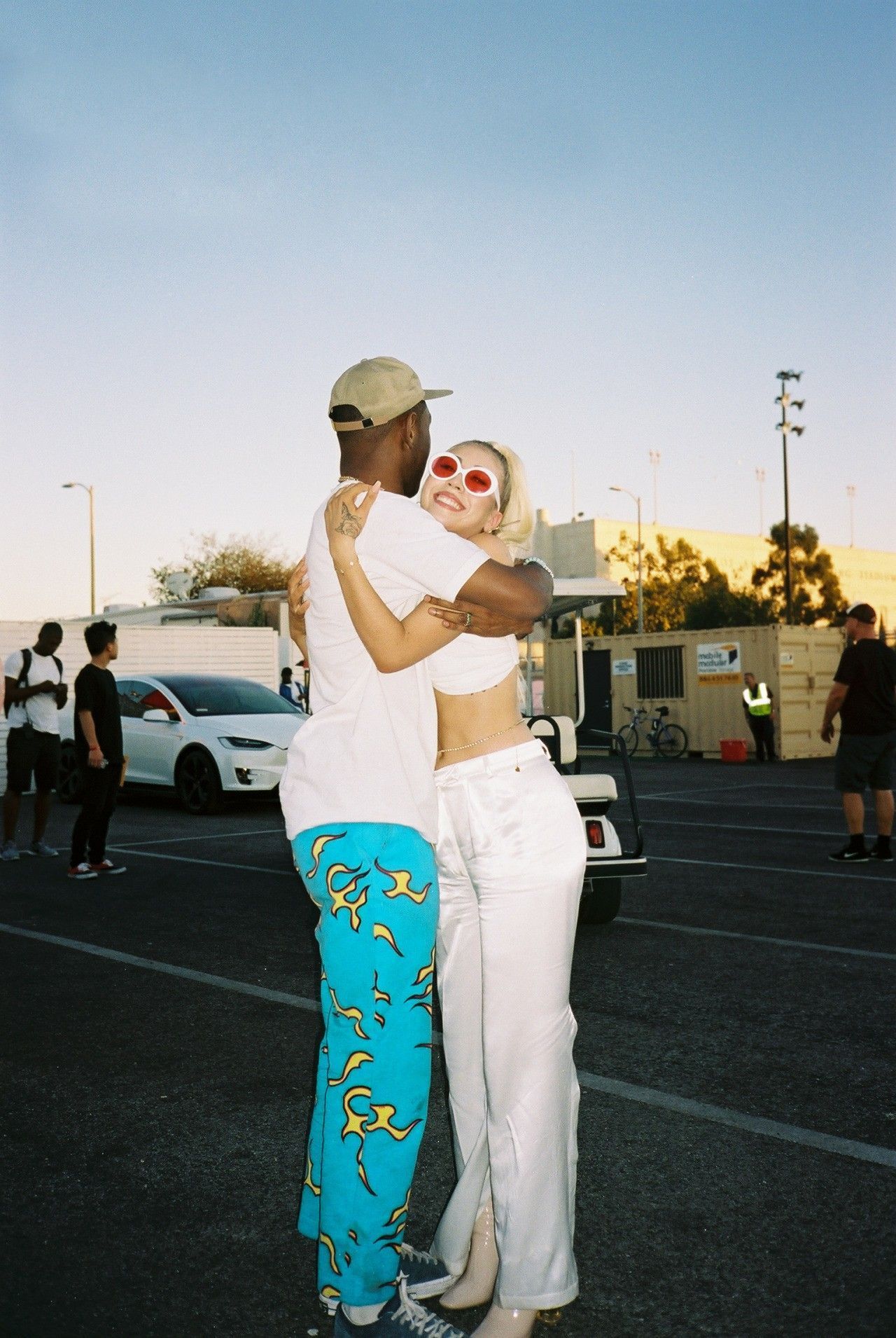 A couple hugging in the parking lot - Kali Uchis