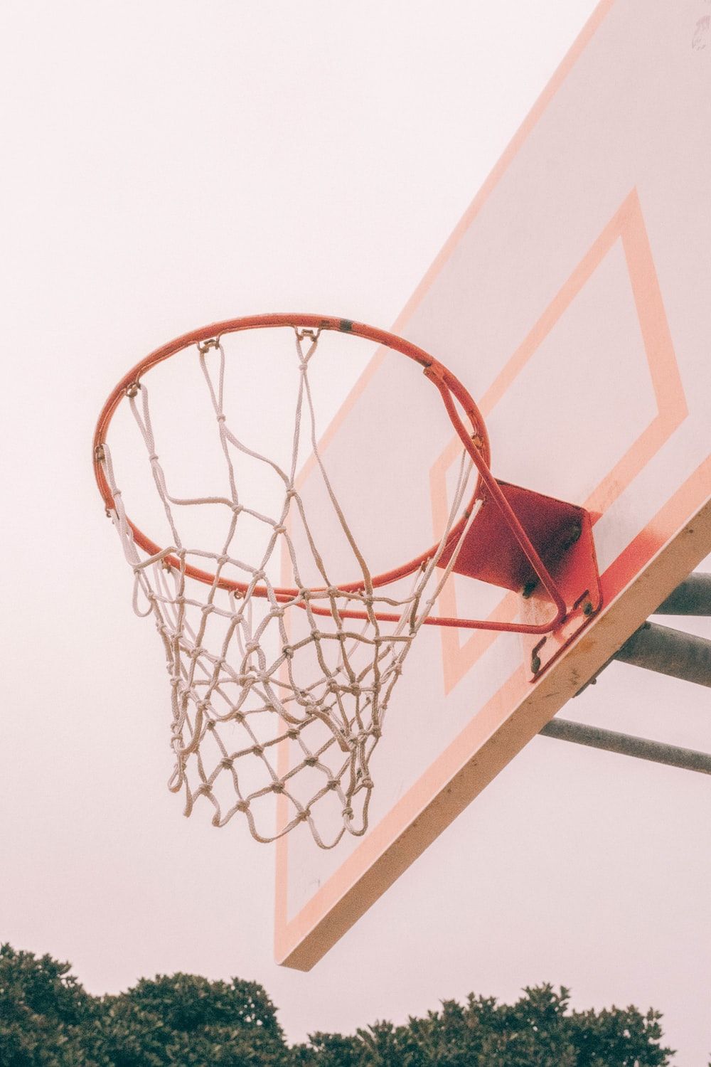 A basketball hoop in a park. - Basketball