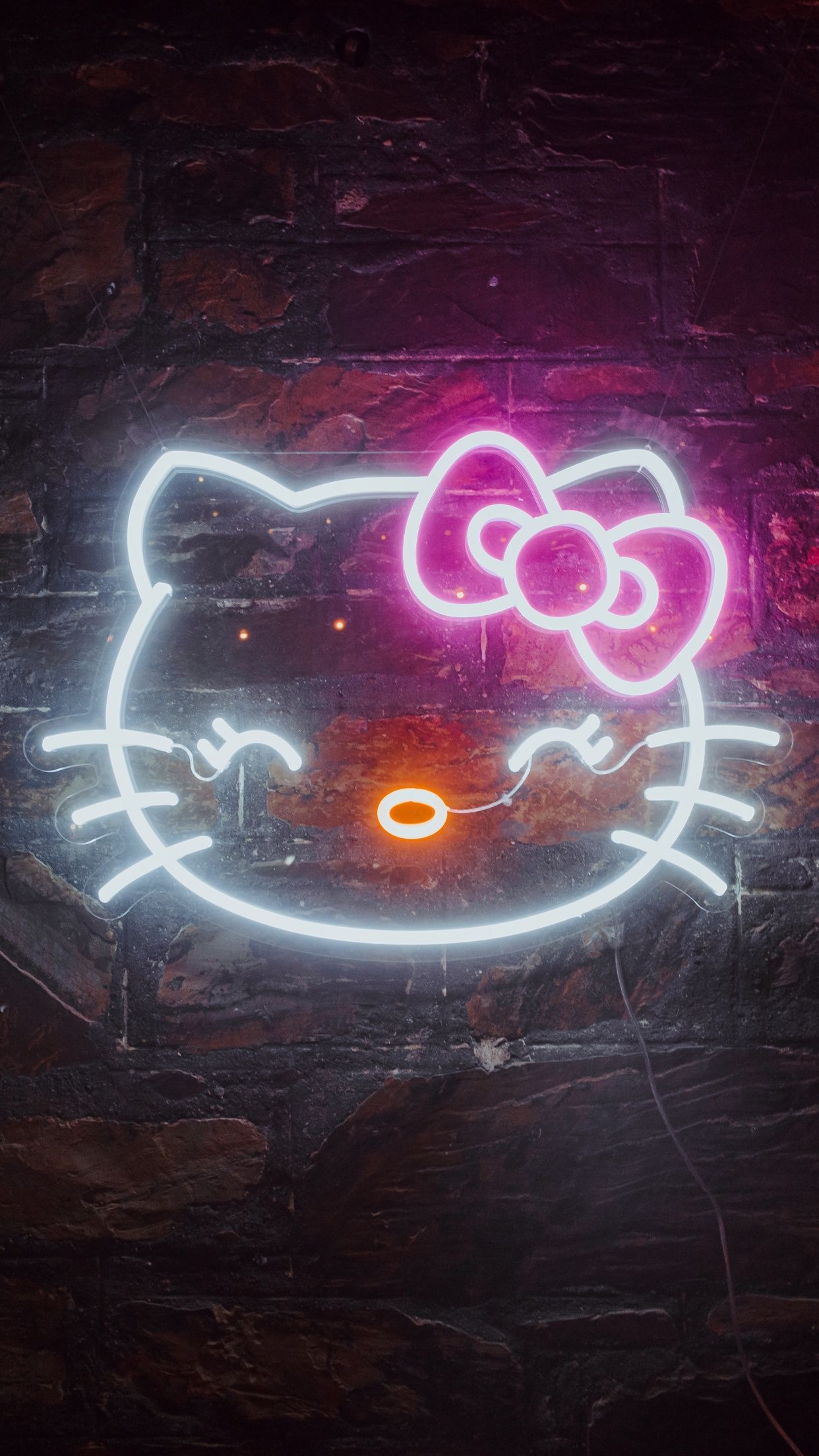 A neon hello kitty sign on the wall - Sanrio