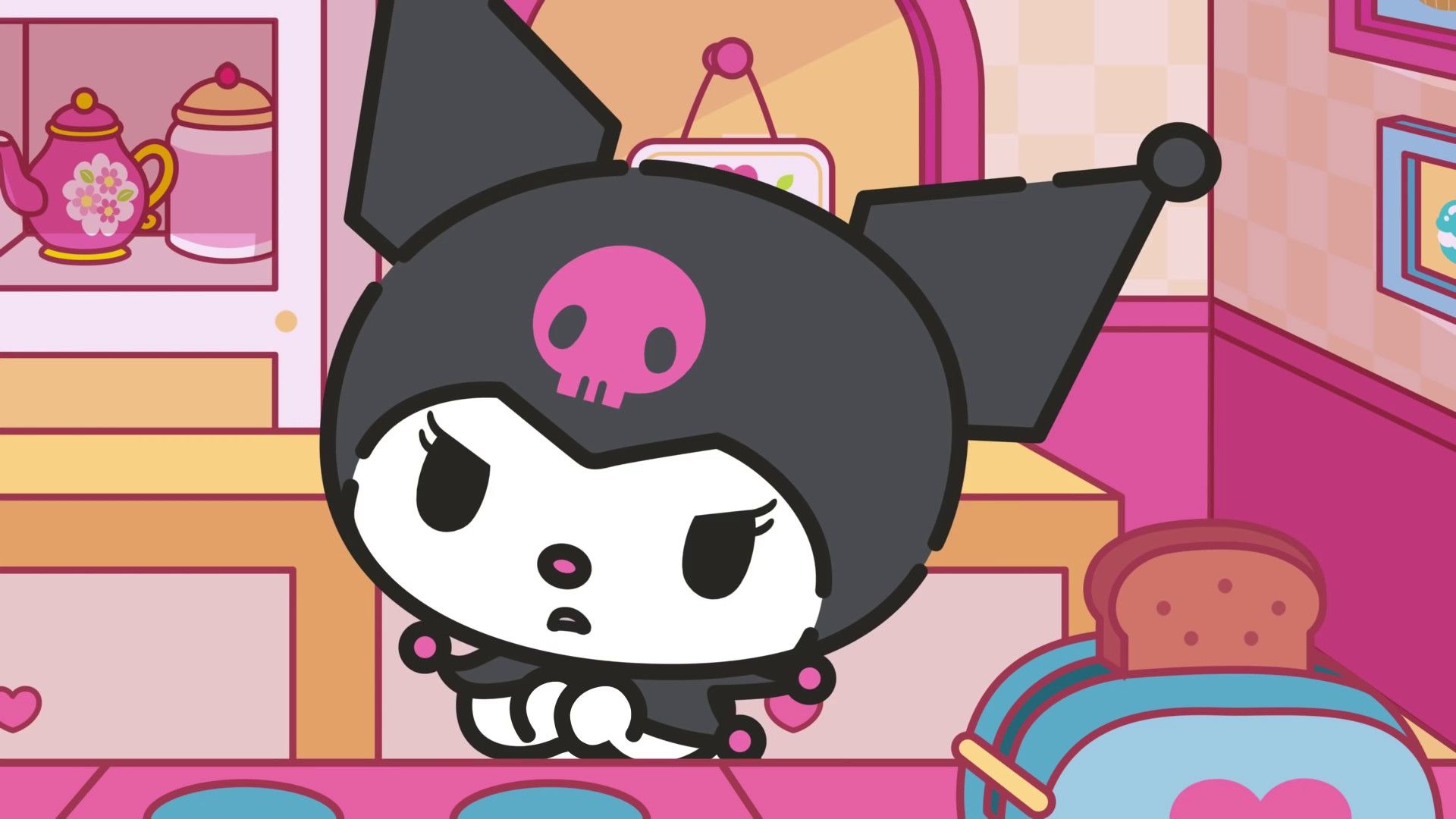 Kuromi is a character from the Sanrio company. She is a black cat with white fur on her belly and paws. She has a pink skull on her head and wears a black pointed hat. She is sitting on a table and looking down. - Sanrio