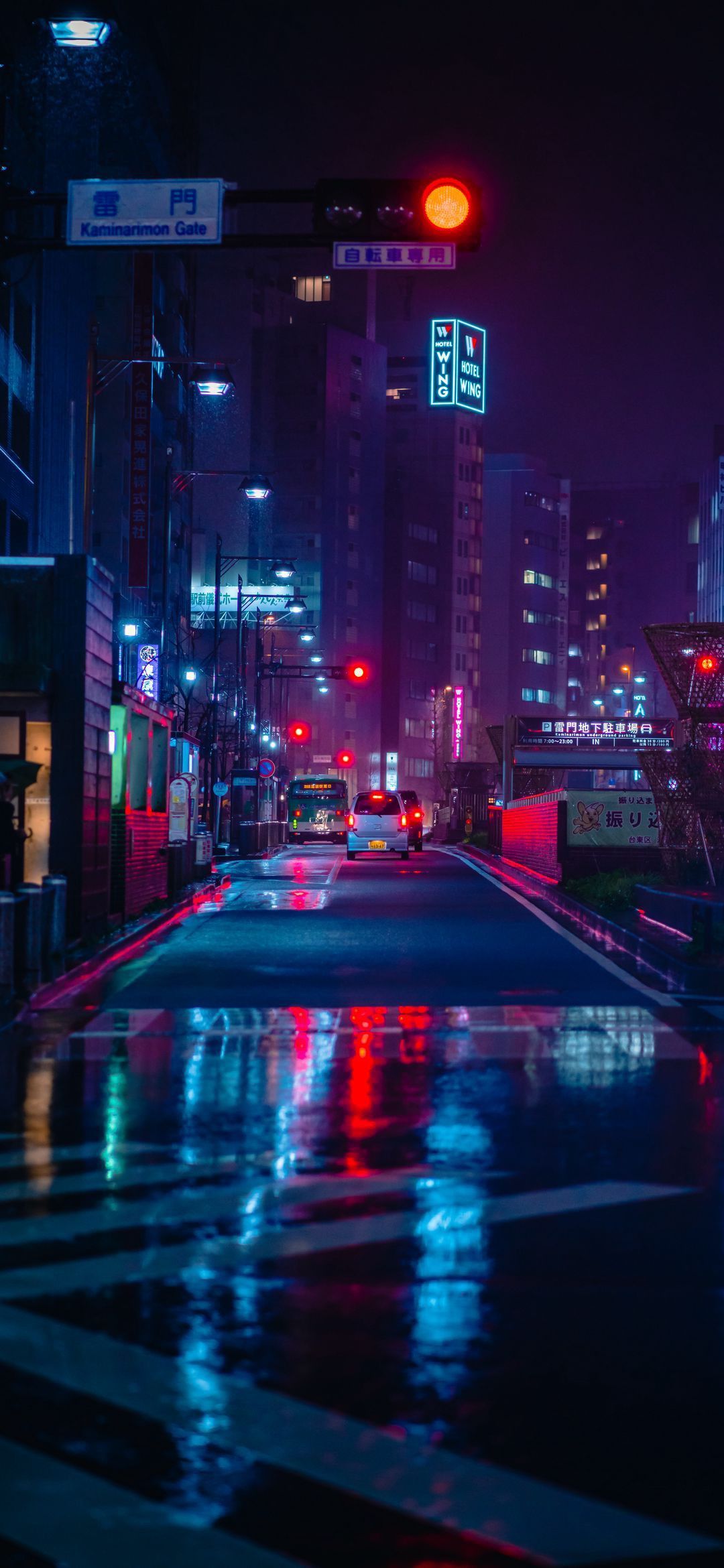 A city street at night with lights on - Cyberpunk
