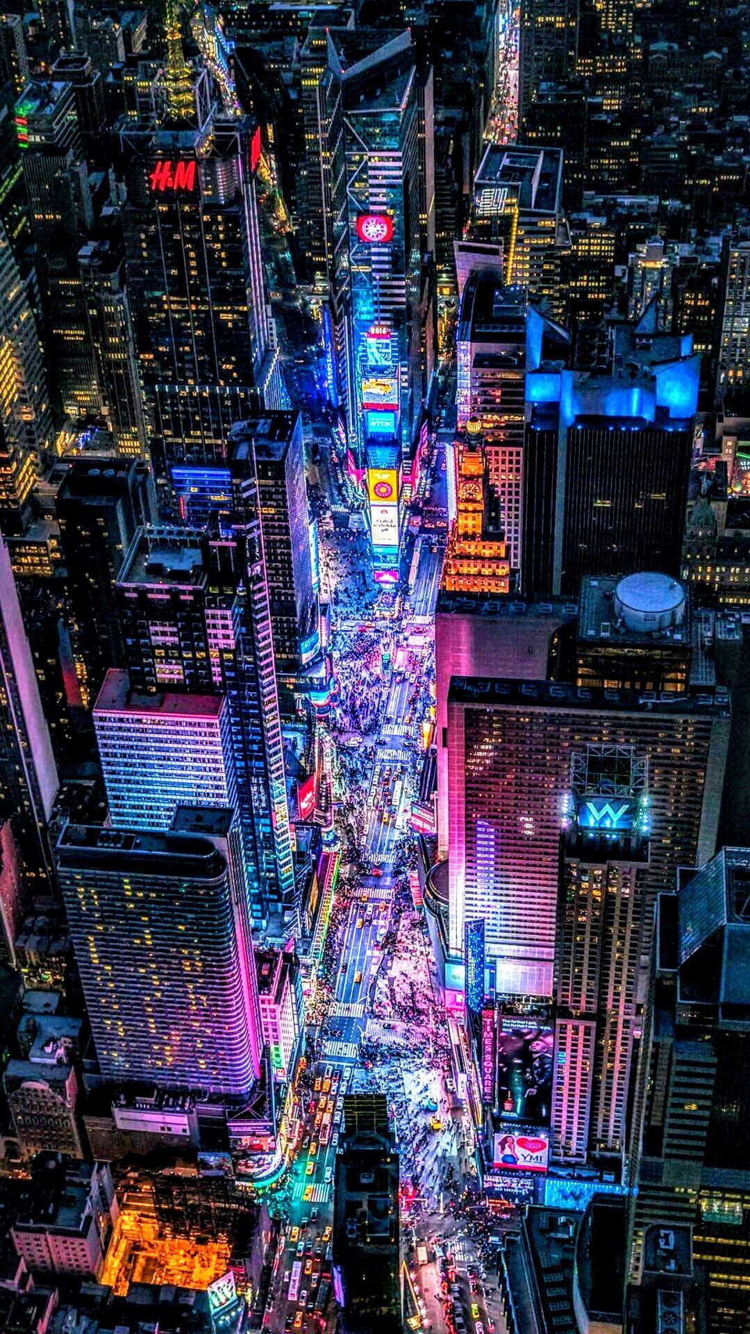 IPhone wallpaper of Times Square in New York City at night, taken from a high angle looking down on the neon lights and crowds. - Cyberpunk, Cyberpunk 2077