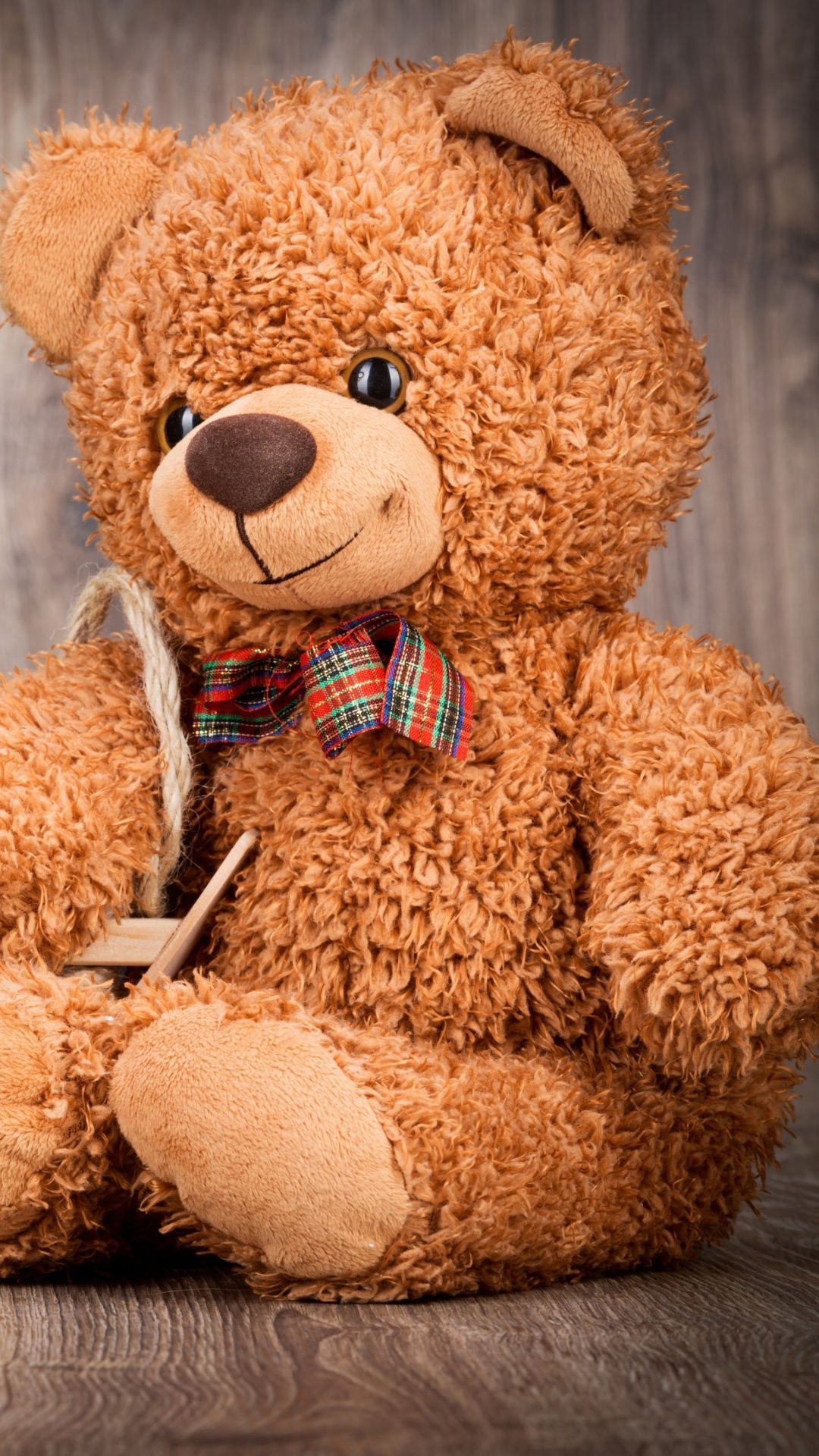A brown teddy bear sitting on the floor - Teddy bear