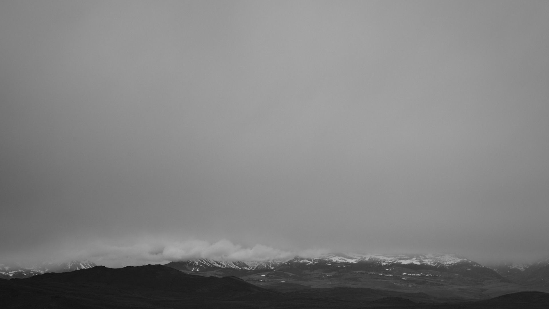 A black and white photo of snowy mountains - Black