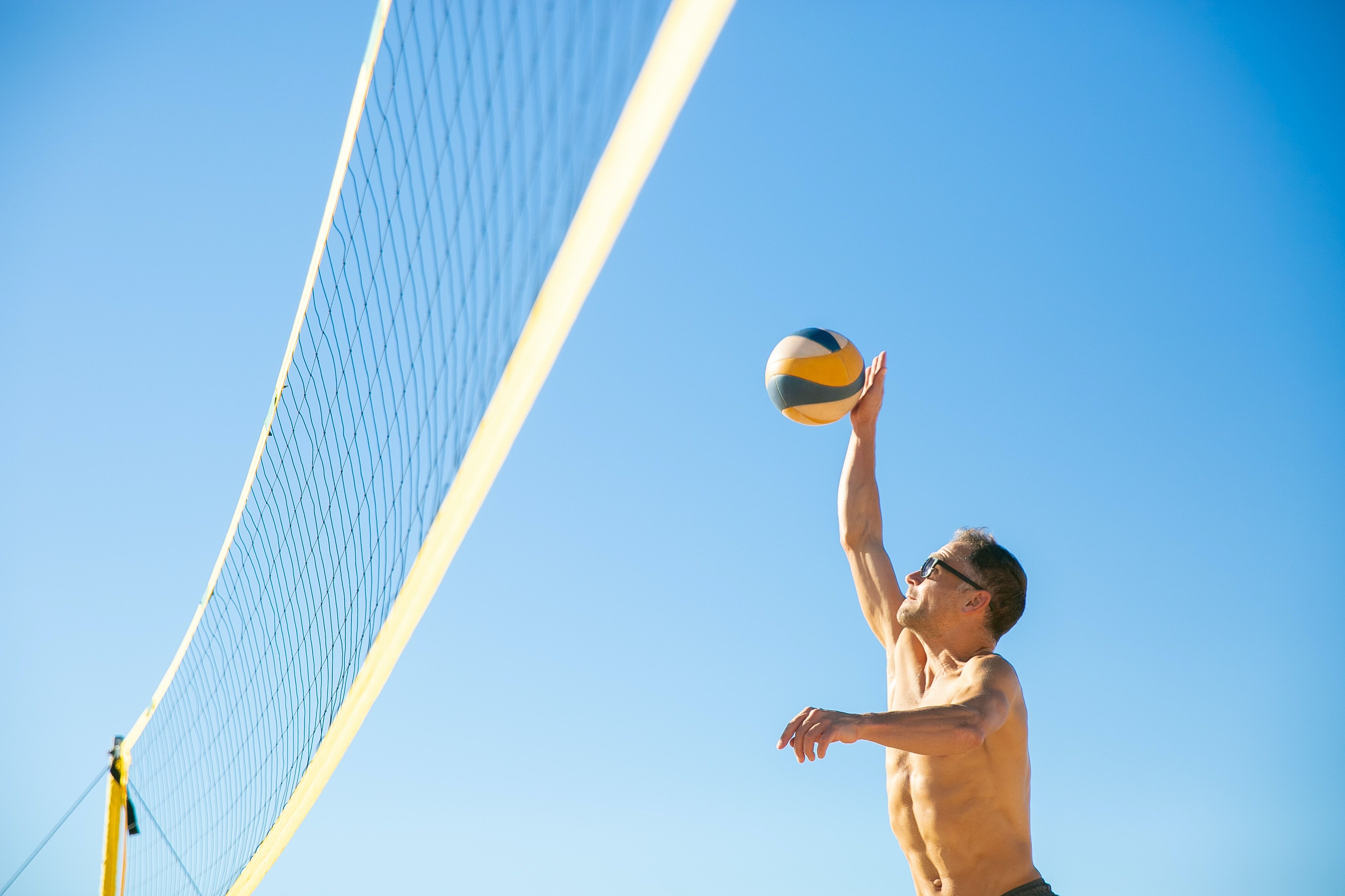 A Man Playing Volleyball on the Beach · Free