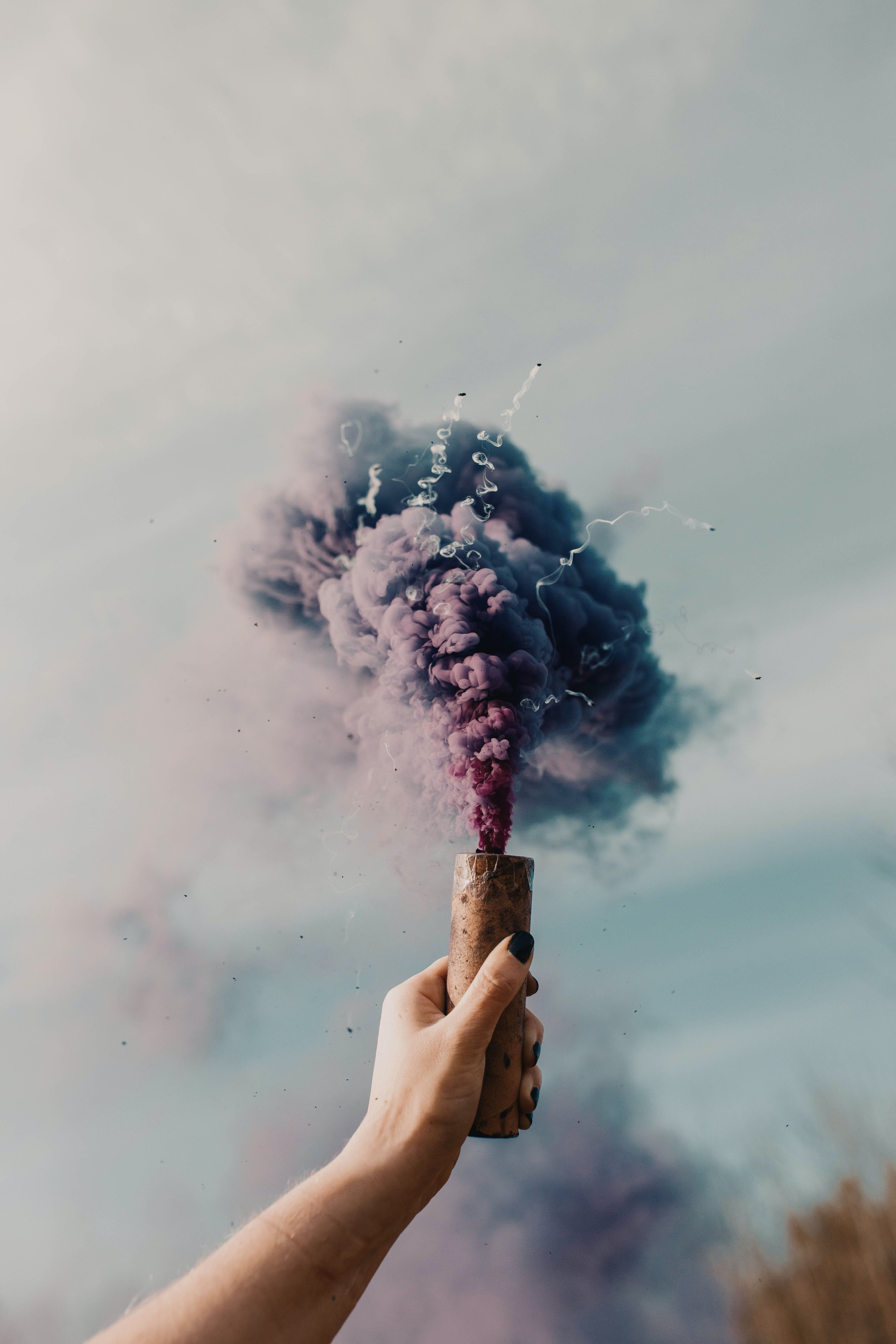 A person holding up some purple smoke - Smoke