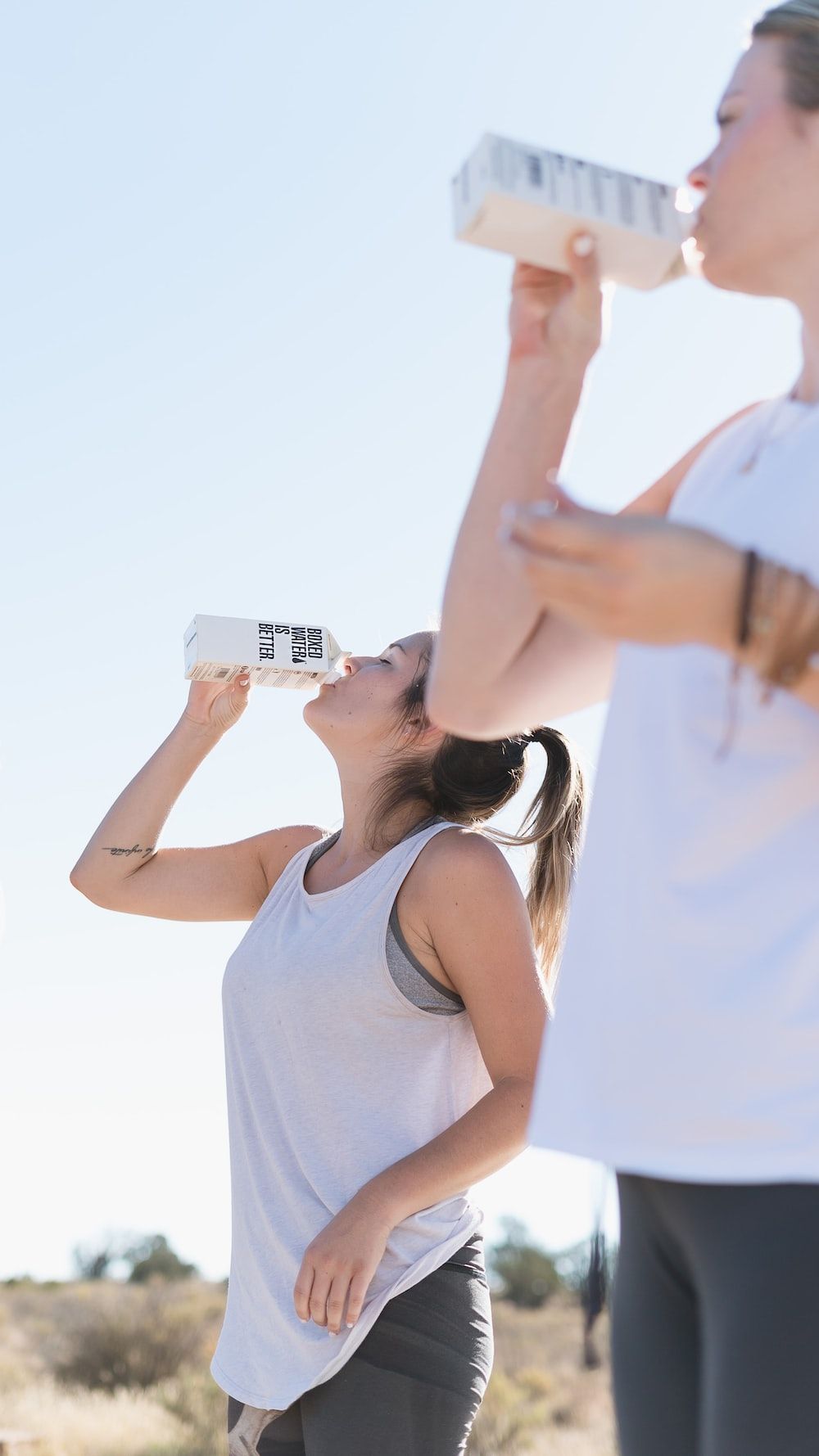 Two women drinking water from a box - Gym