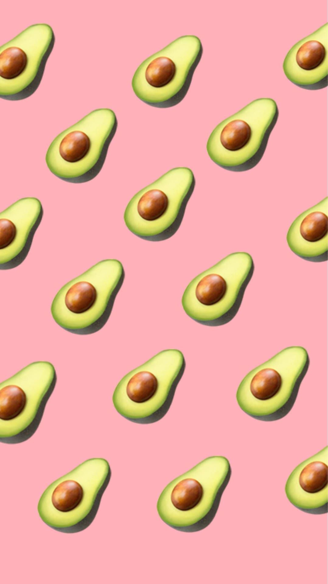 A pattern of avocados on pink background - Avocado