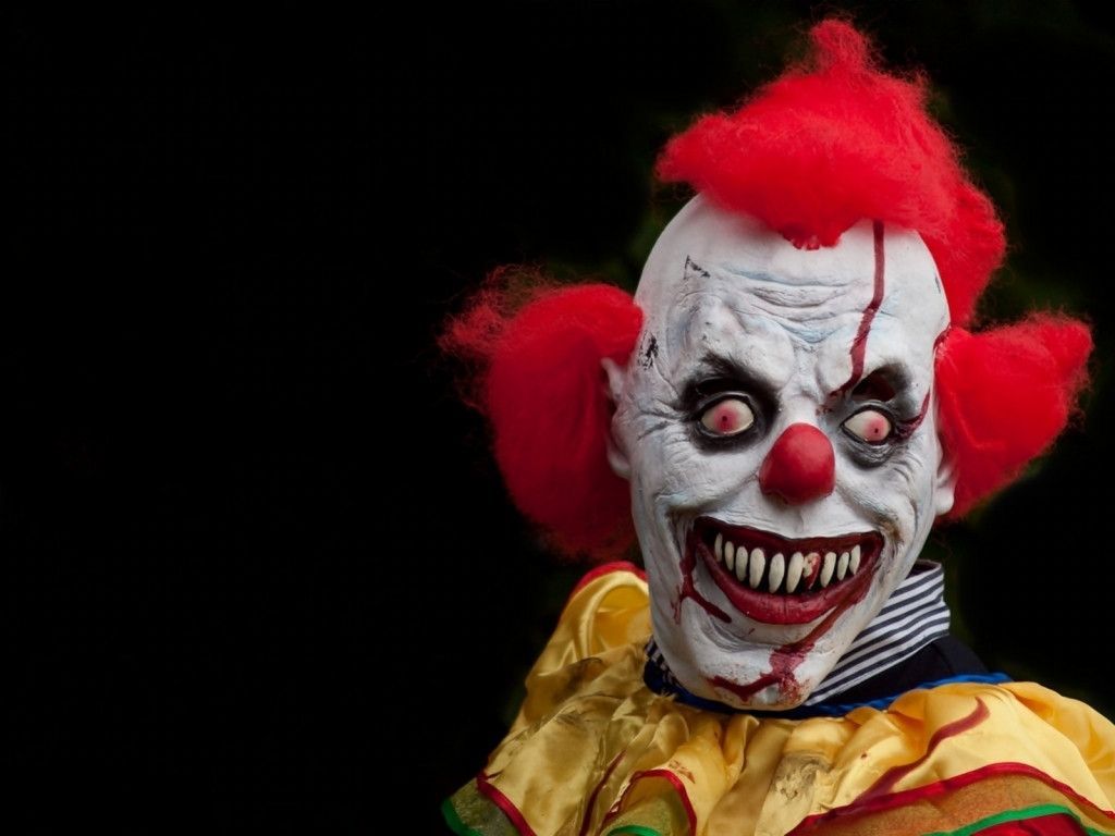 A scary clown with red hair and a creepy smile. - Clown