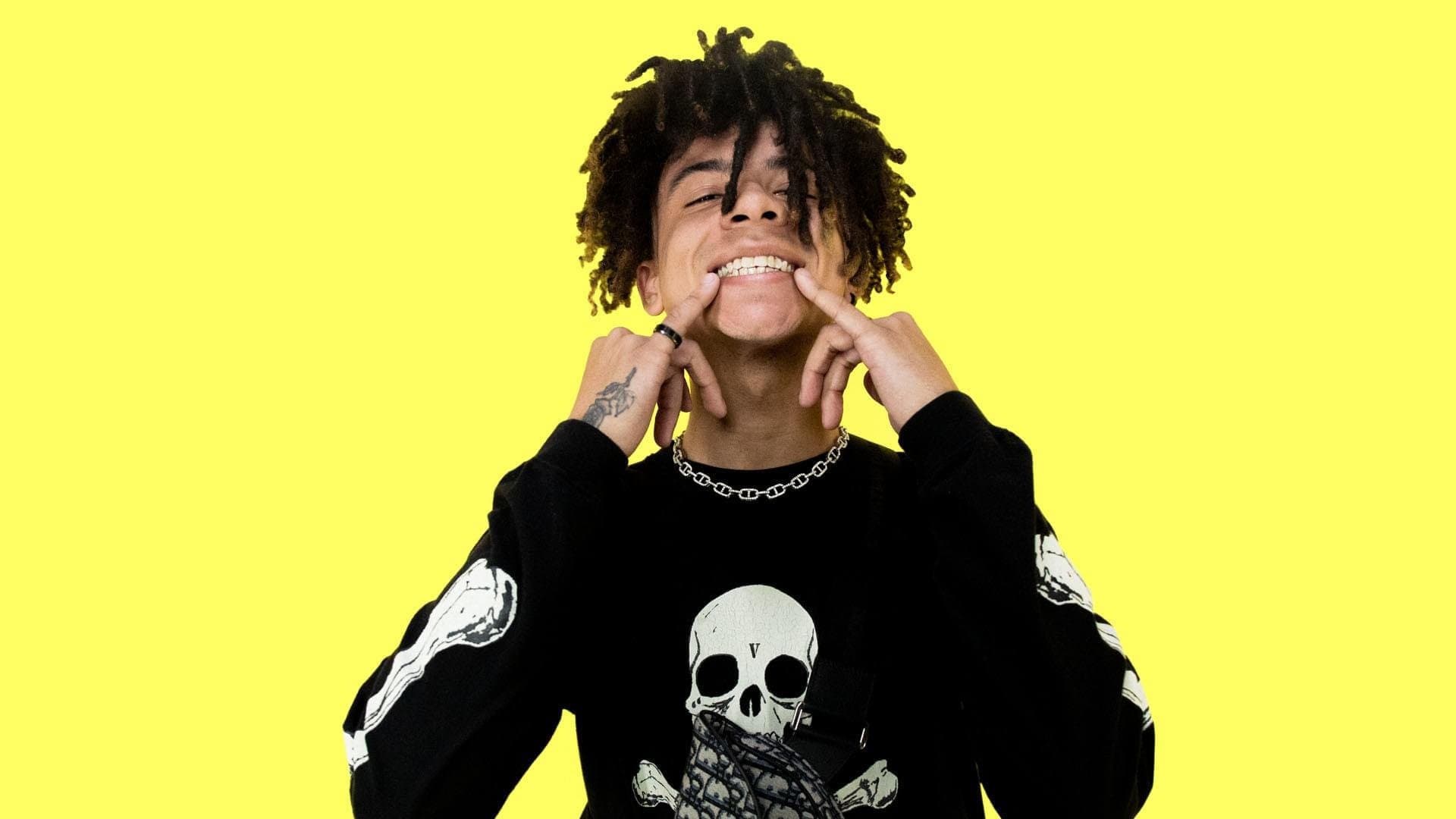 Lil Pump in a black sweater and a yellow background - Dior