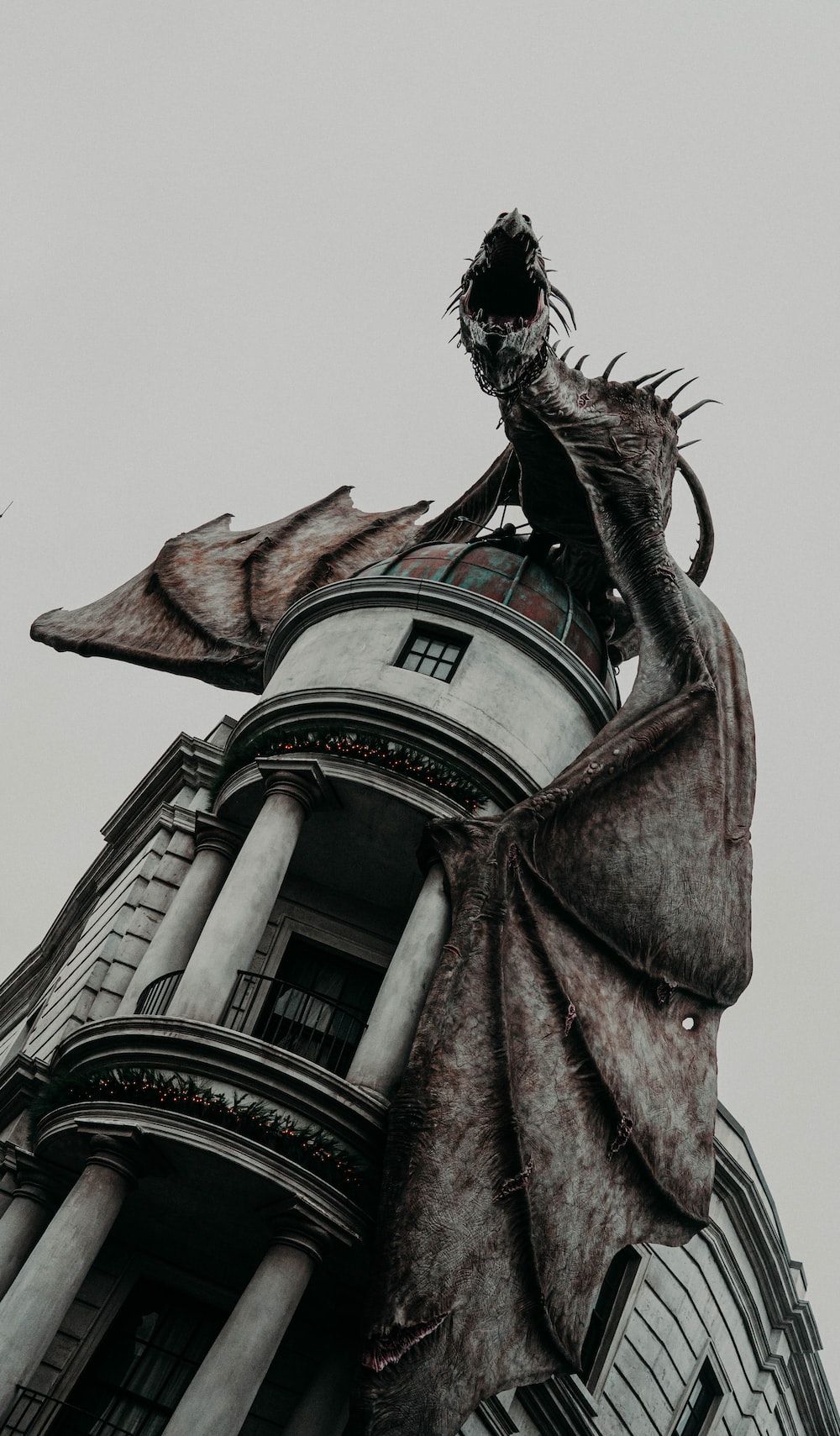 A dragon statue on top of a building - Dragon