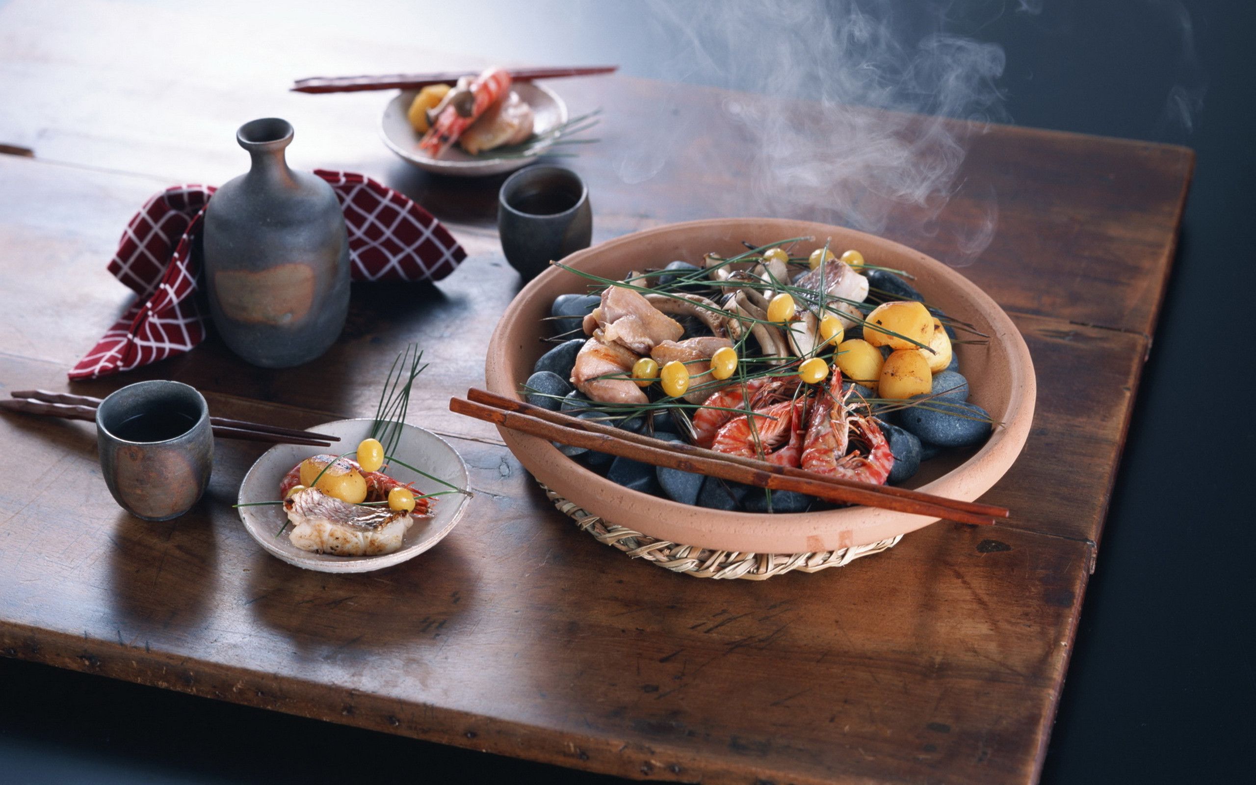 A steaming bowl of seafood on a wooden table - Foodie