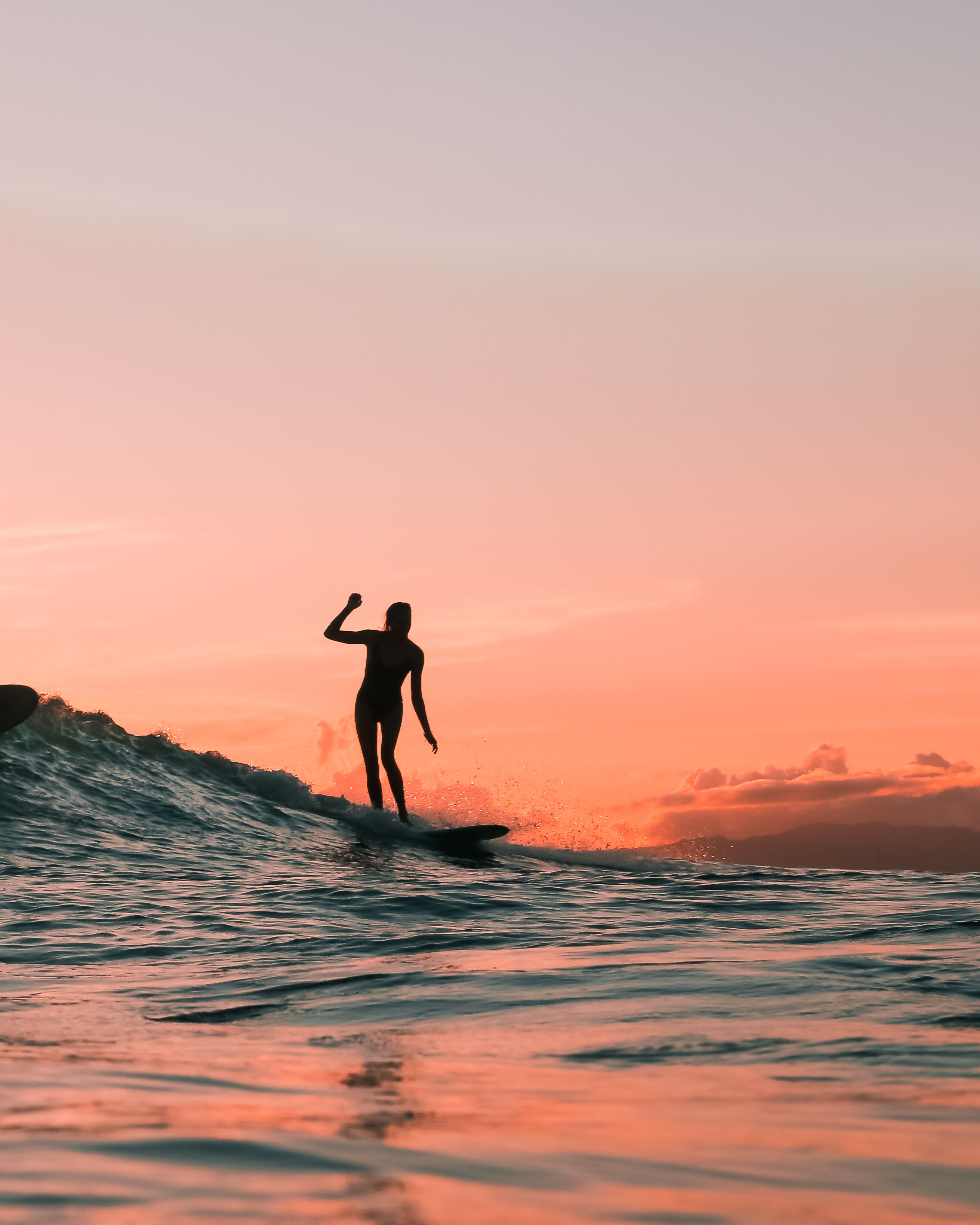 Silhouette of a Person Surfing During Sunset · Free