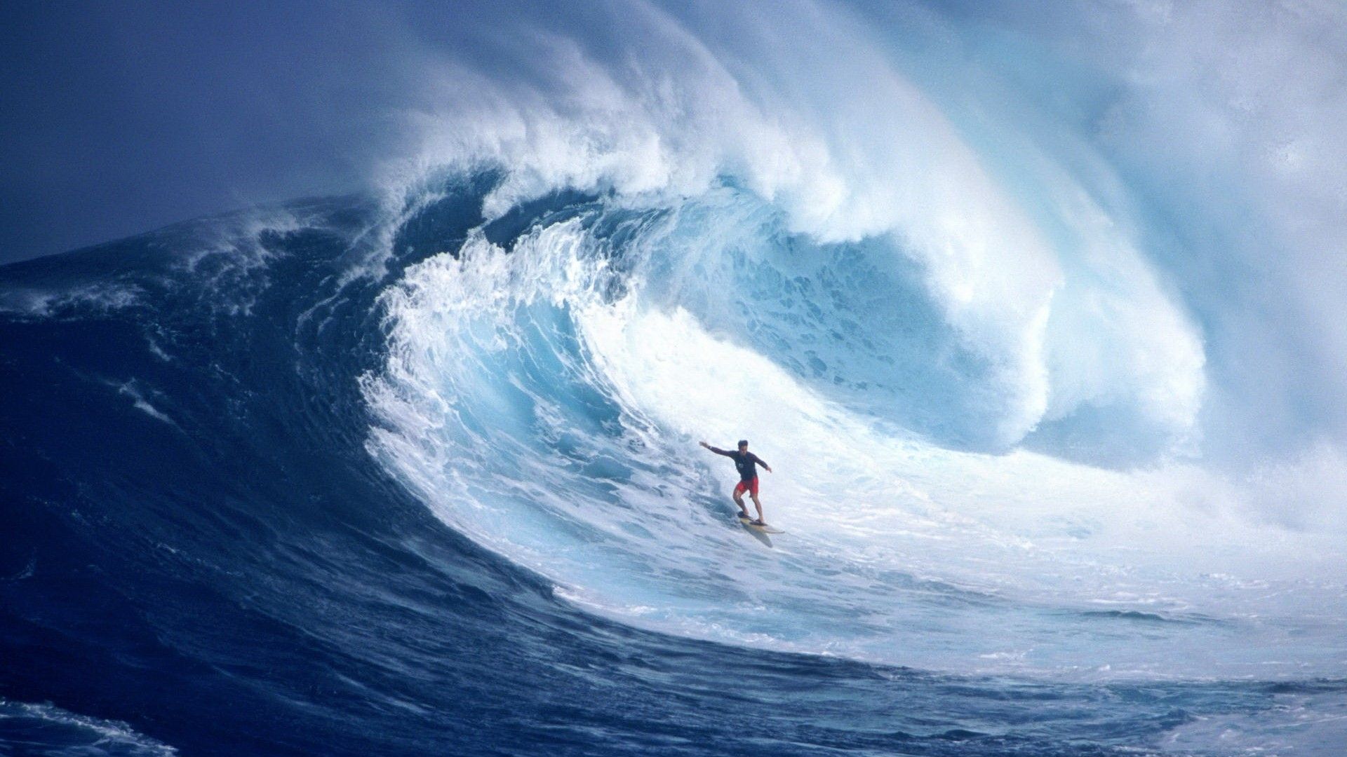 A man riding on top of an ocean wave - Surf