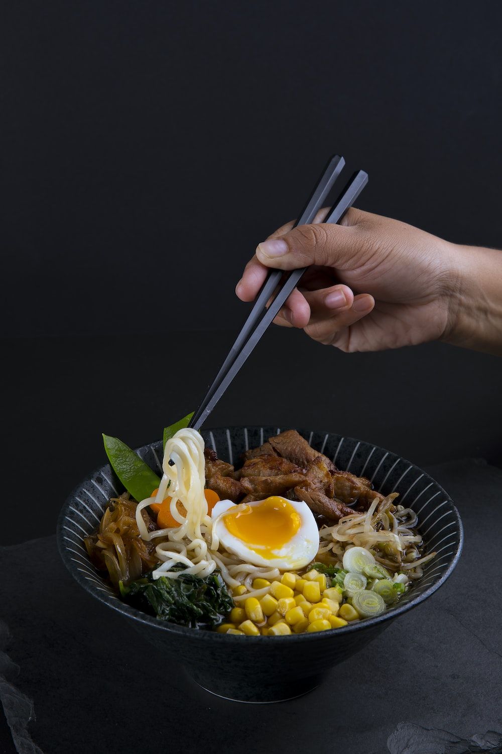 A bowl of ramen with chopsticks in hand - Ramen