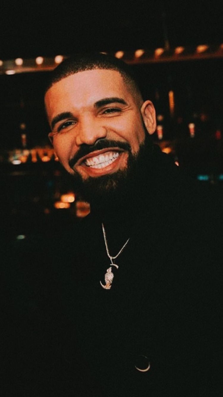 Drake smiling with a black background - Drake