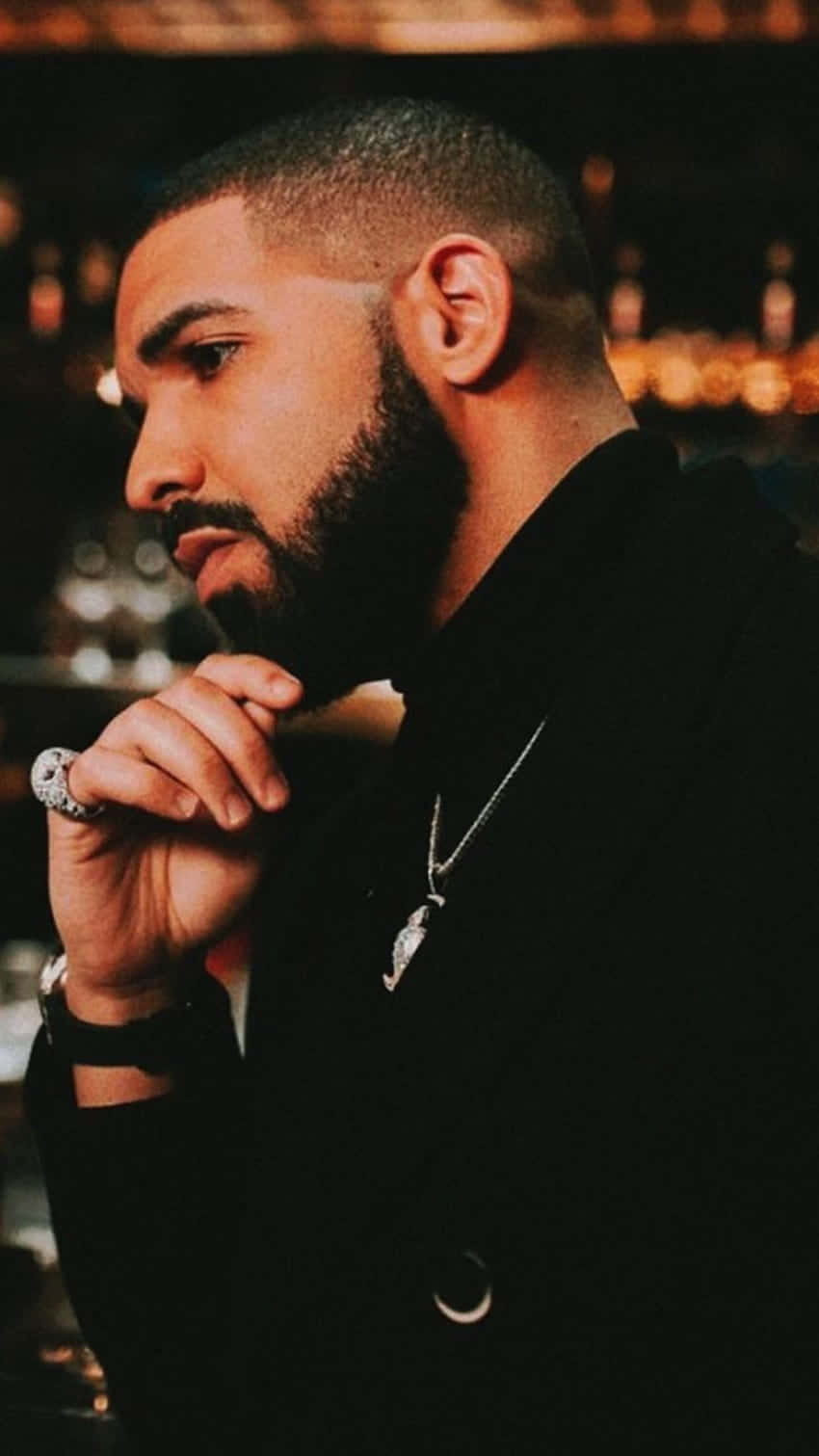 Drake with a beard and a black shirt - Drake