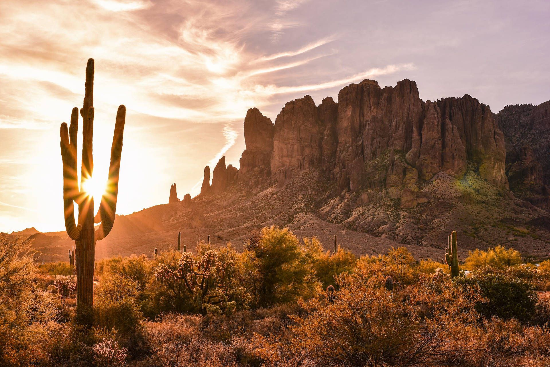 The sun setting behind the Superstition Mountains in Arizona. - Desert