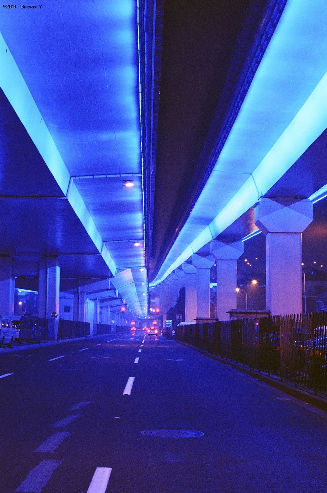 A blue tinted bridge with white pillars - Indigo