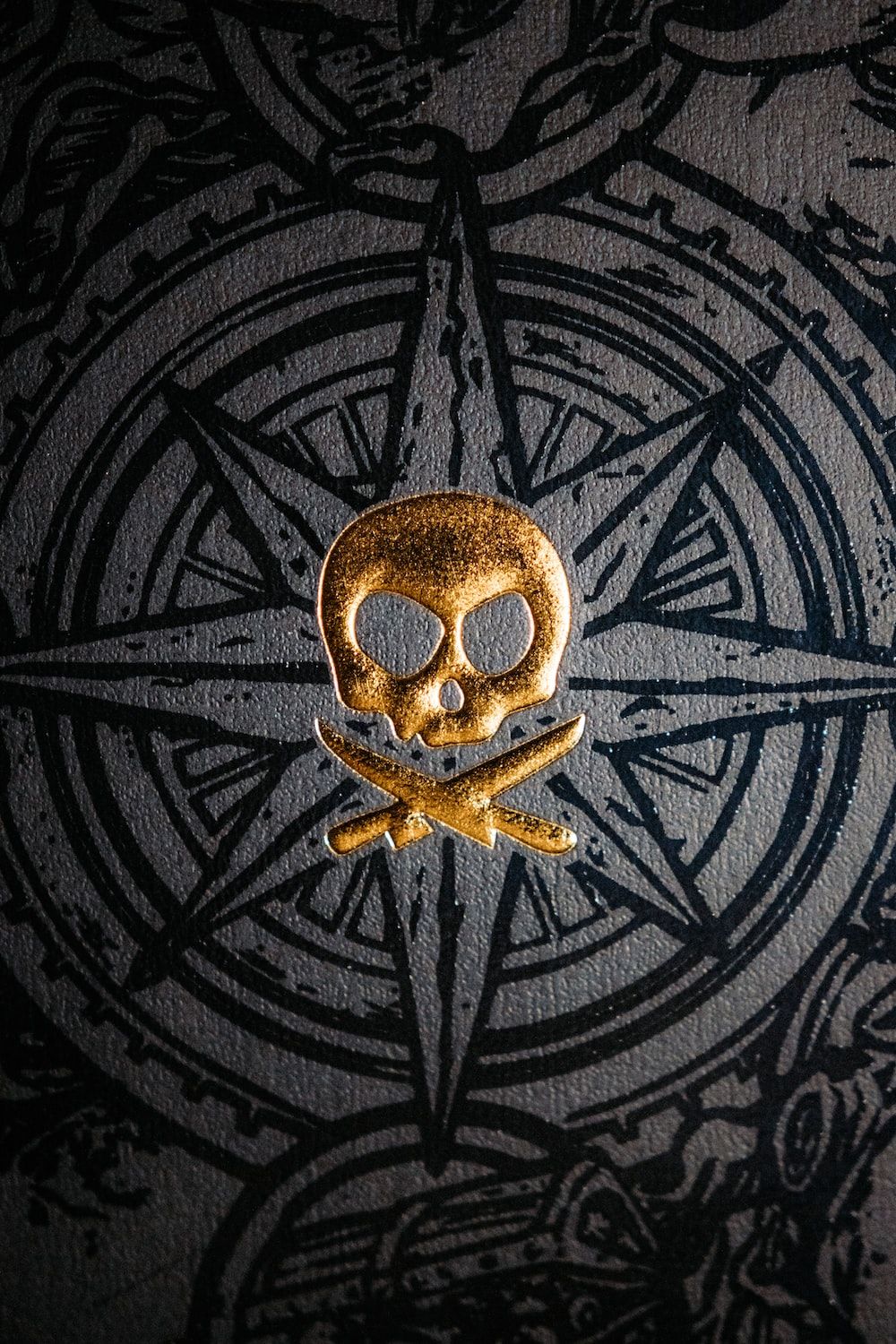 A gold skull and crossbones on top of an image - Pirate