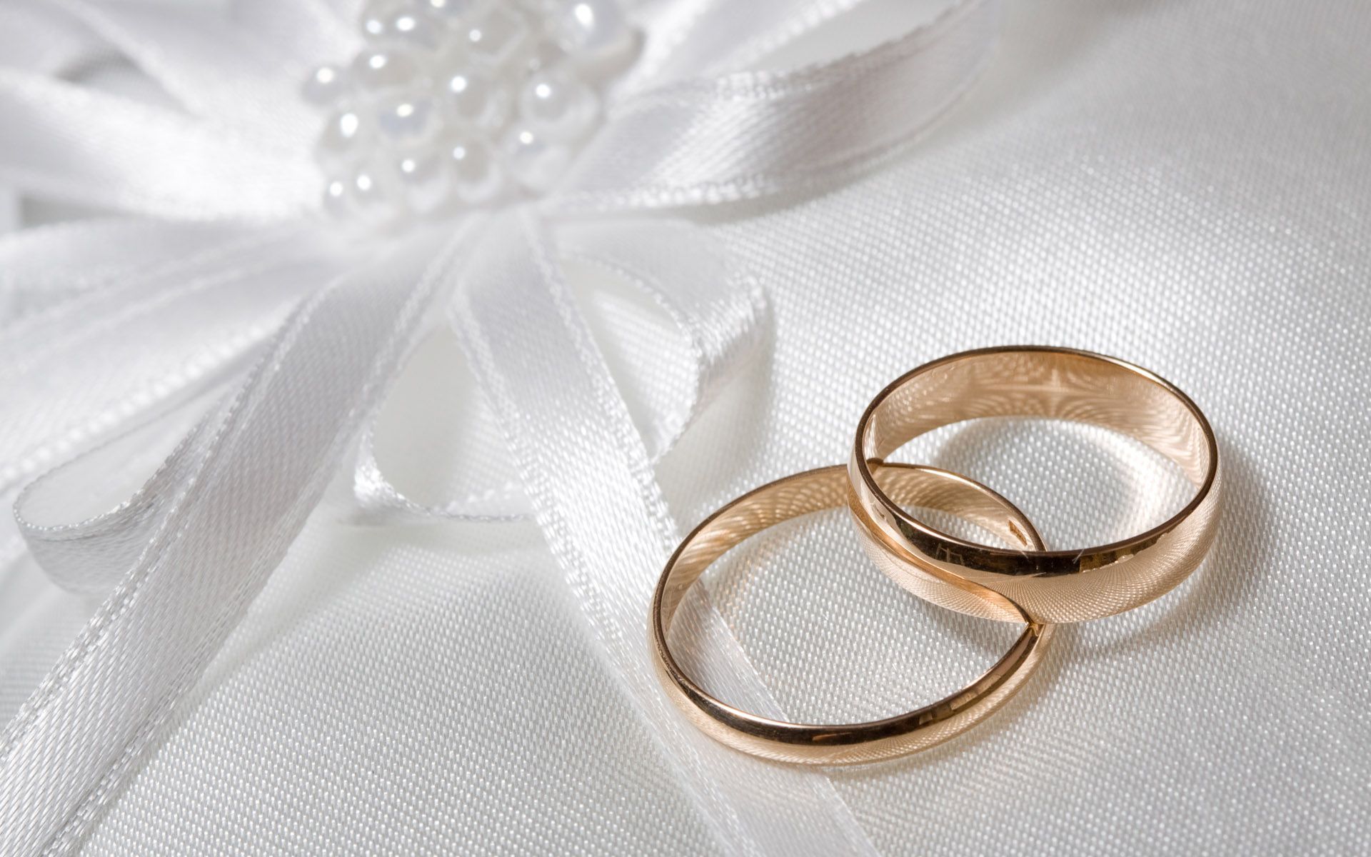 Two gold wedding rings on a white cloth - Wedding