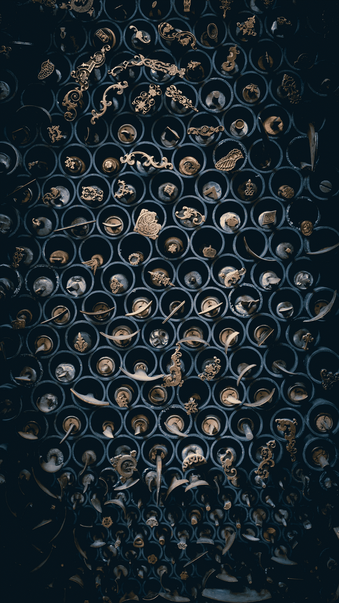A dark image of a wall with many circular patterns and small metal objects. - Castle, Slytherin