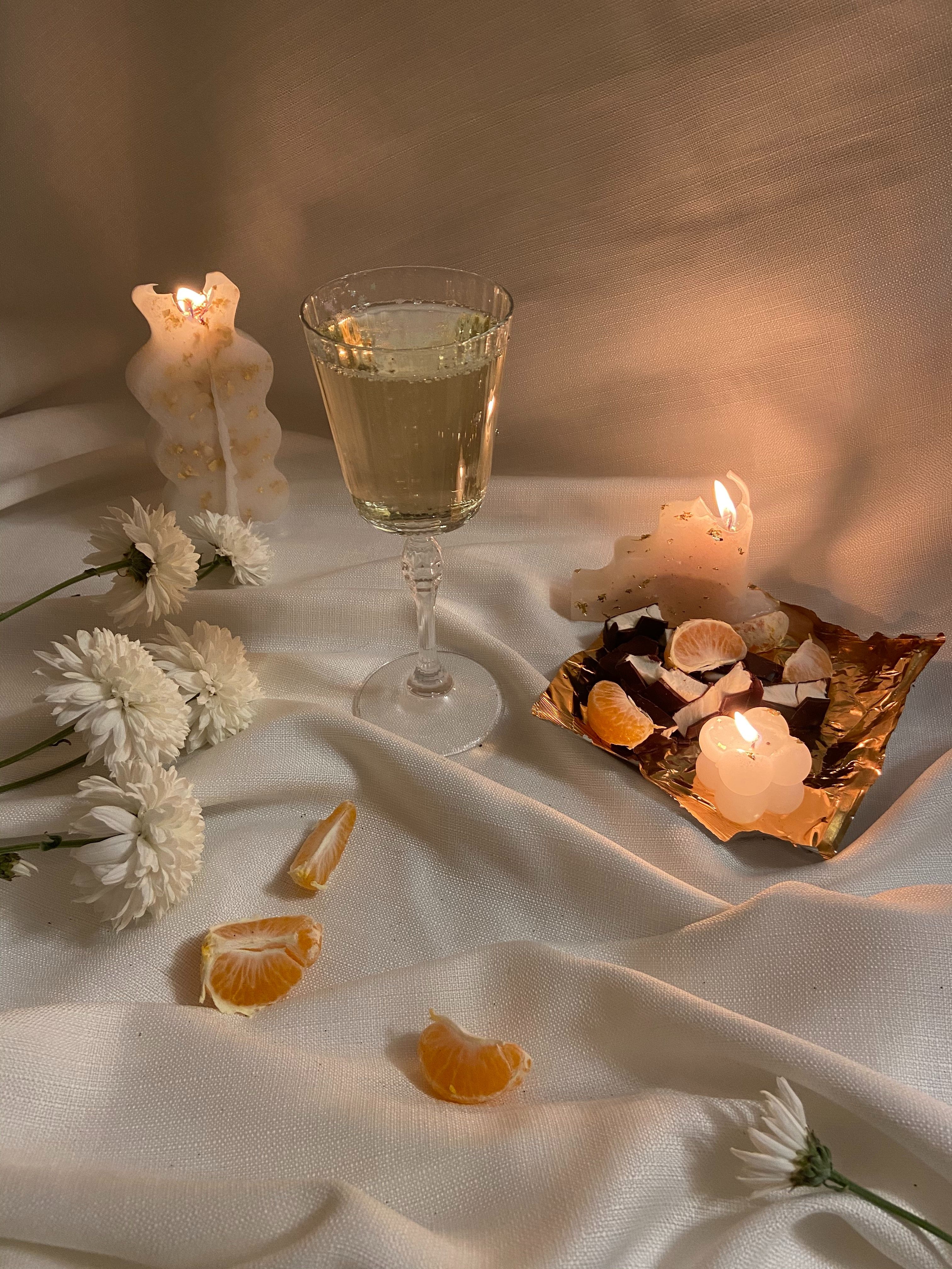 A table with candles and wine glasses - Champagne